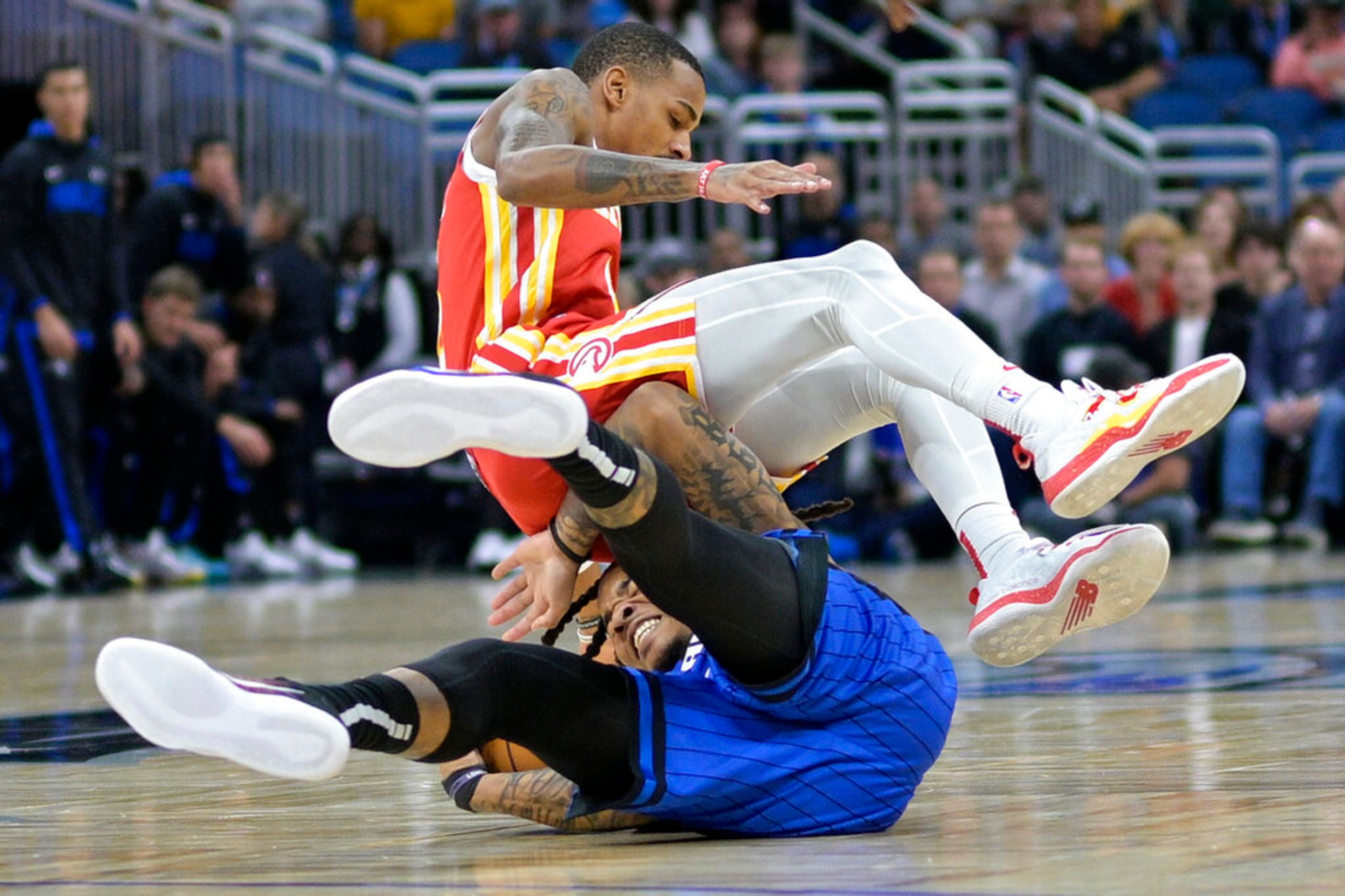 Atlanta Hawks guard Dejounte Murray lands on top of Orlando Magic guard Markelle Fultz while going for a loose ball during the first half of an NBA basketball game Wednesday, Nov. 30, 2022, in Orlando, Fla. (AP Photo/Phelan M. Ebenhack)