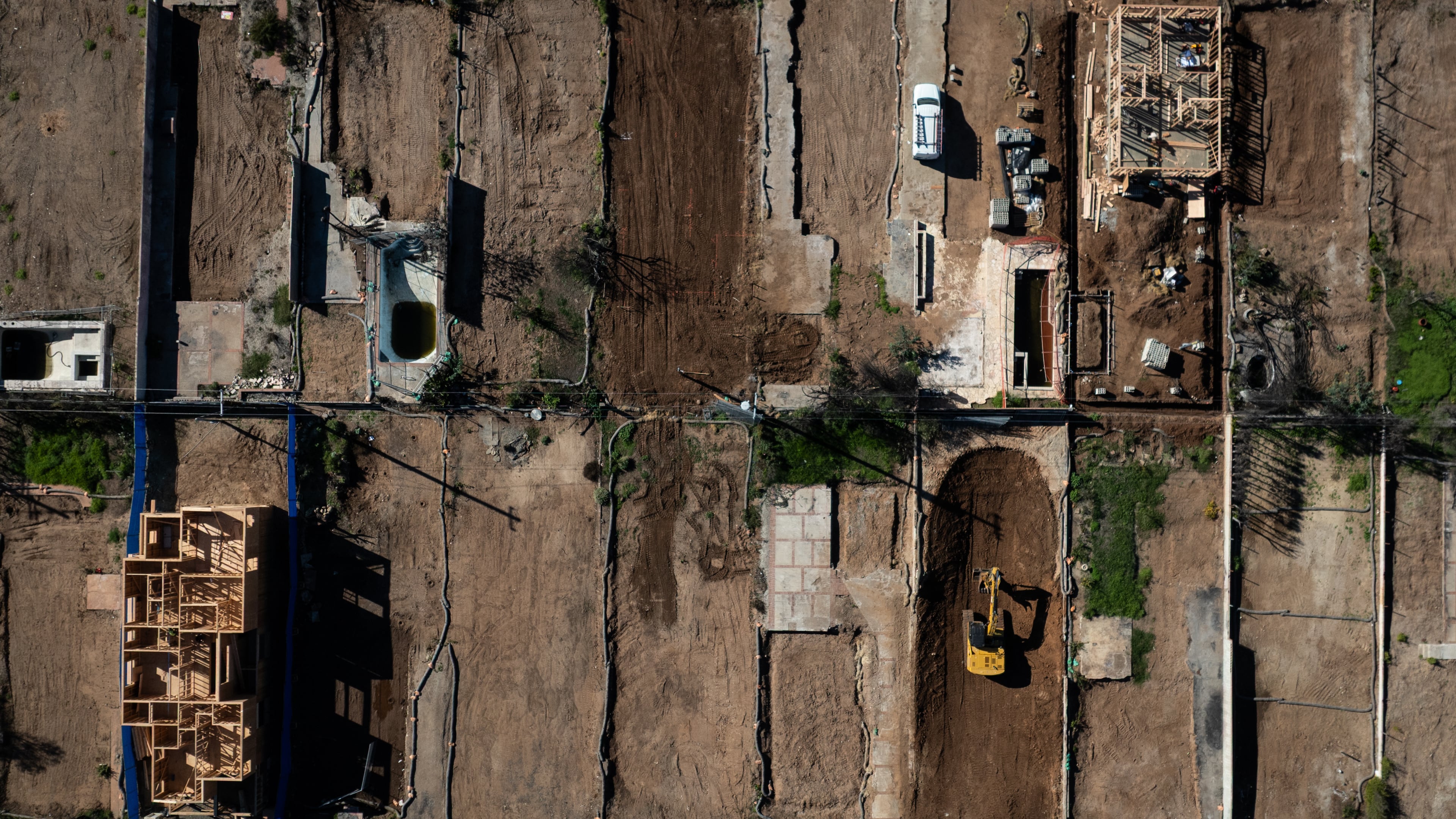 FILE - An aerial view shows houses being rebuilt on cleared lots months after the Palisades Fire, Dec. 5, 2025, in the Pacific Palisades neighborhood of Los Angeles. (AP Photo/Jae C. Hong, File)