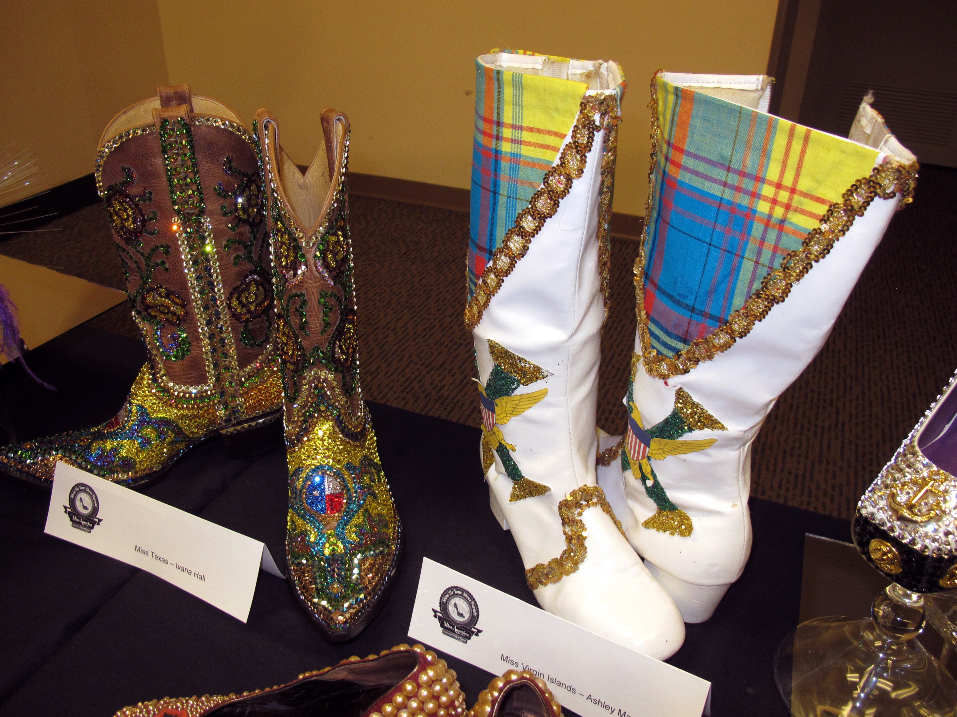 This Sept. 10, 2013, photo shows decorated boots to be worn by contestants Miss Texas, left, and Miss Virgin Islands, in Saturday's "show us your shoes" parade, ahead of the Miss America in Atlantic City, N.J. (AP Photo/Wayne Parry)