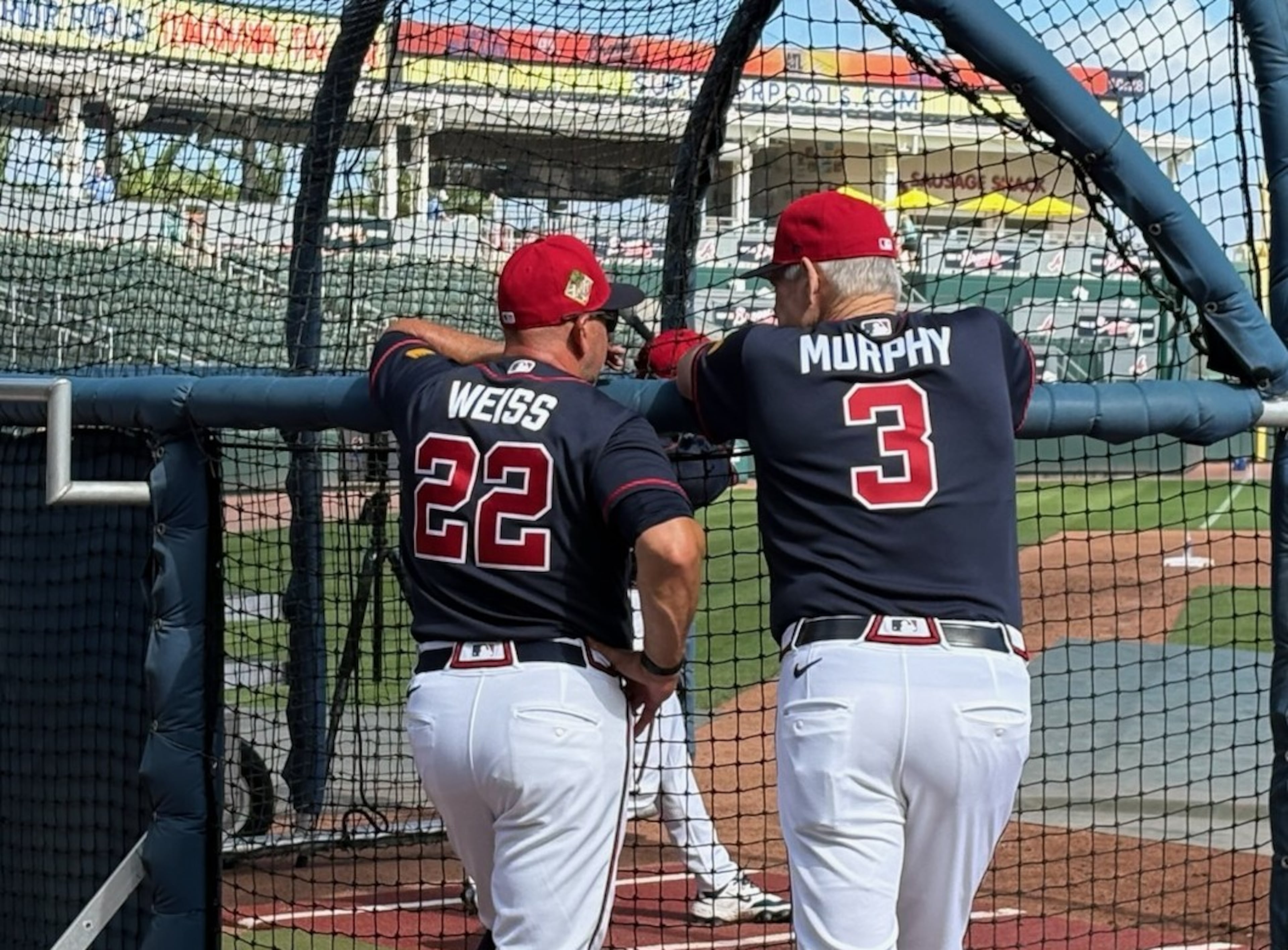 Braves legend Dale Murphy (right) chats with manager Walt Weiss before Thursday's spring training game.