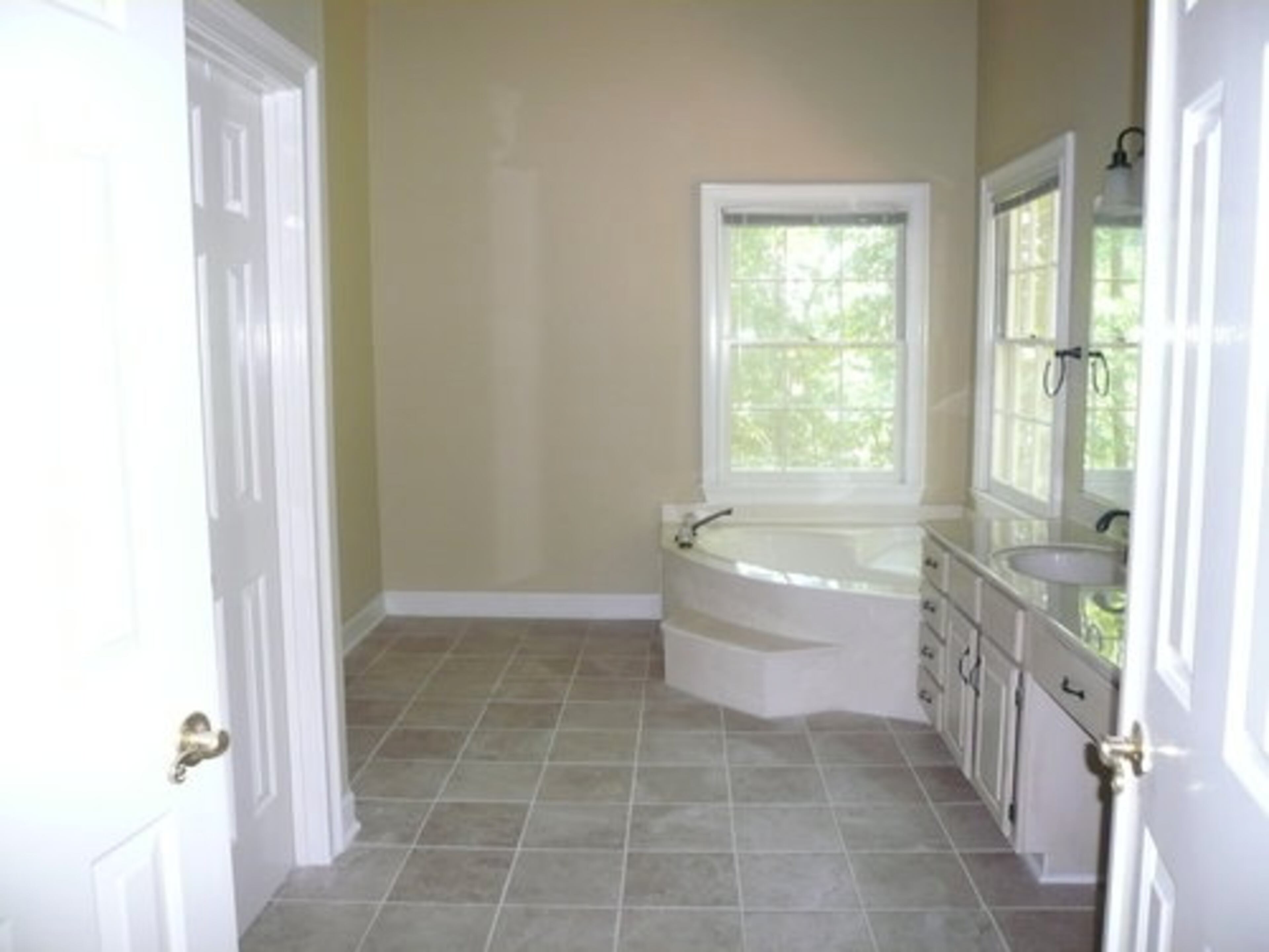 Before staging, the master bathroom is stark and uninviting.