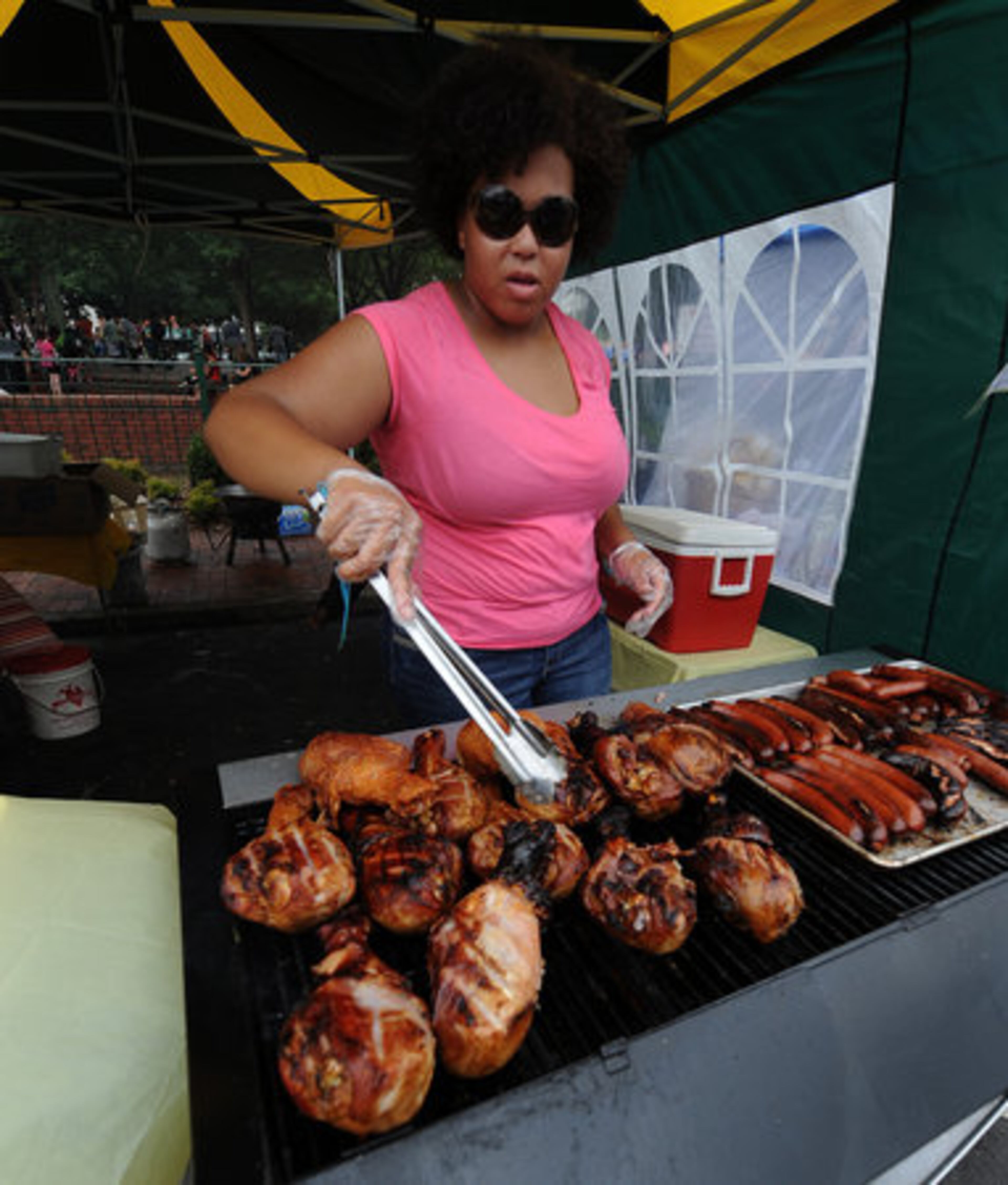 Shamoya Bailey cooks turkey legs during the Cobb County branch of the NAACP 8th Annual Marietta Juneteenth Celebration on historic Marietta Square on Saturday, June 18, 2011.