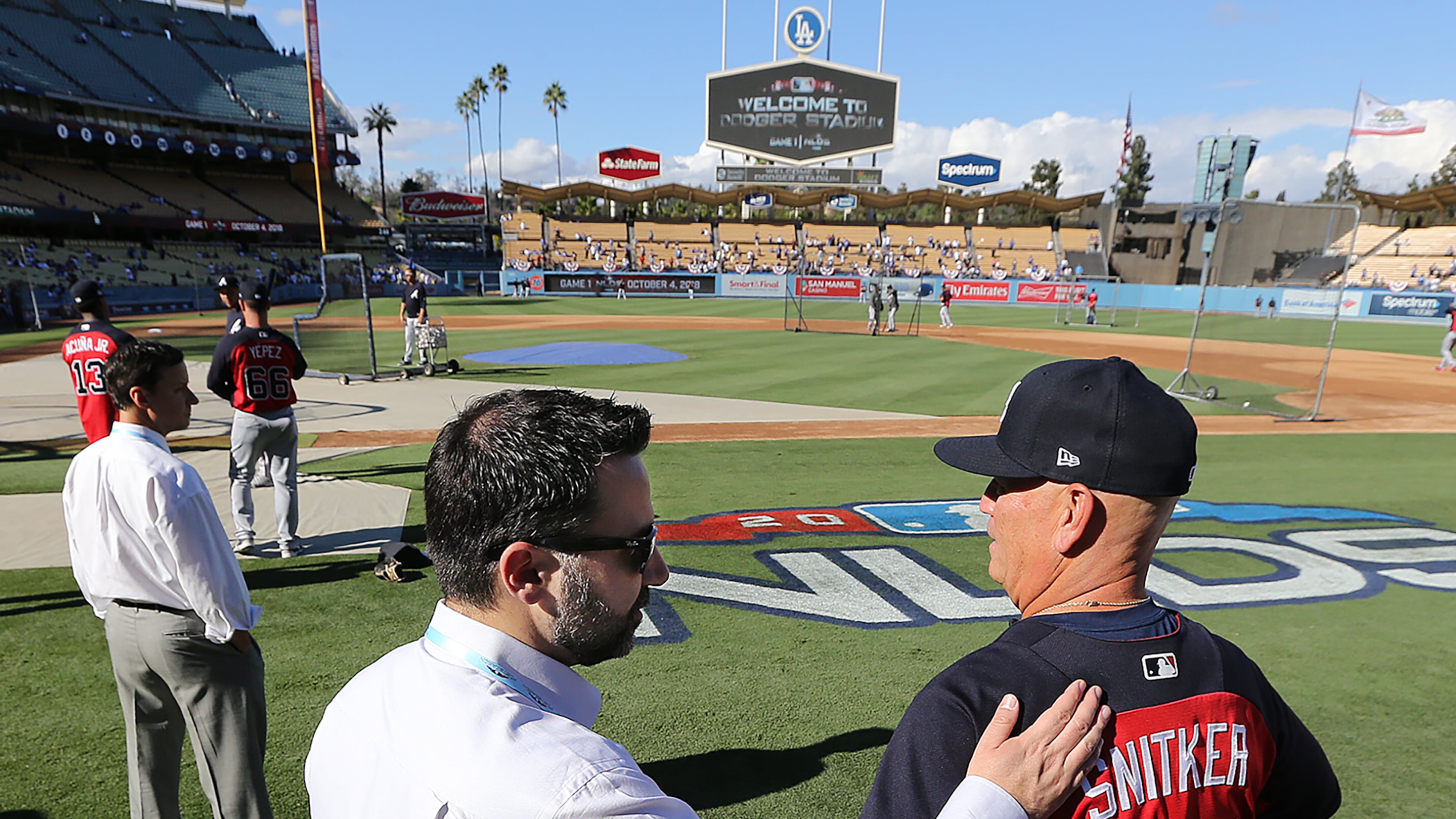 Braves general manager Alex Anthopoulos gives manager Brian Snitker a pat on the back before playing the Los Angeles Dodgers during Game 1 of the National League Division Series on Thursday, Oct 4, 2018, in Los Angeles. Curtis Compton/ccompton@ajc.com
