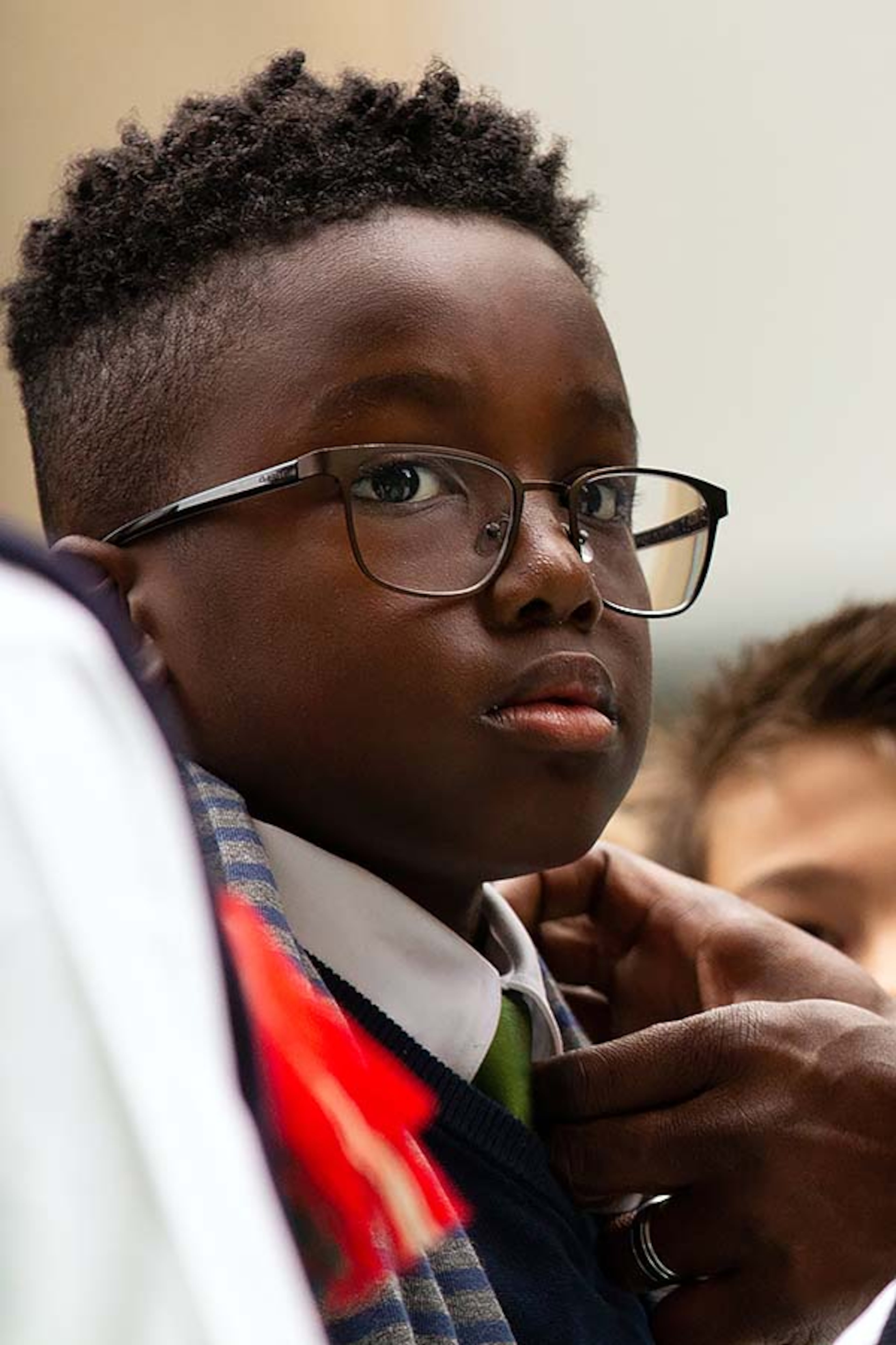 A boy gets his collar adjusted before singing at the ChildrenâÃôs Christmas Parade benefitting ChildrenâÃôs Healthcare of Atlanta in midtown Atlanta, Georgia, on Saturday, Dec. 7, 2019. (Photo/Rebecca Wright)