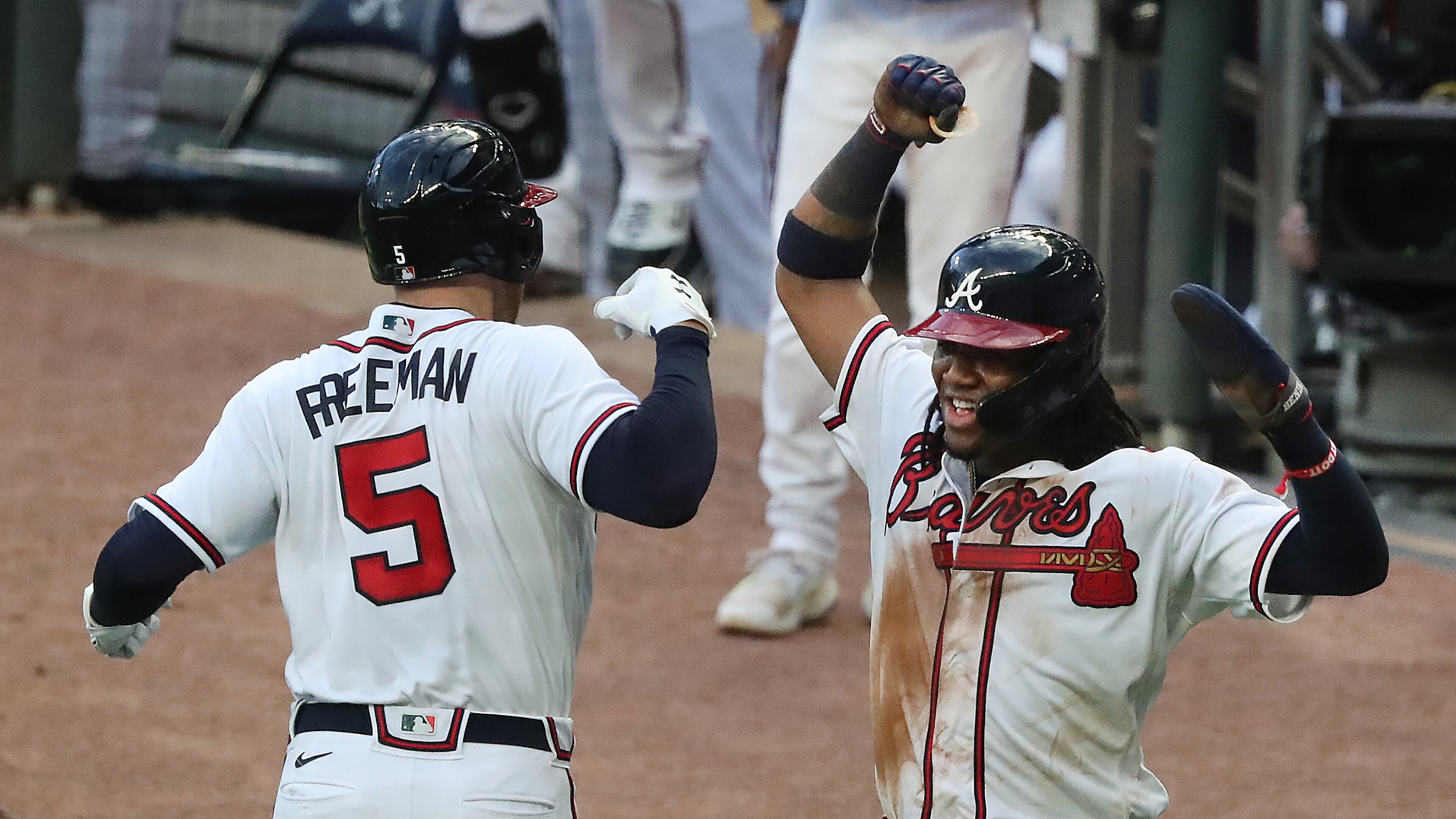 Freddie Freeman celebrates with Ronald Acuna during a Braves game last season at Truist Park. (Curtis Compton/ccompton@ajc.com)