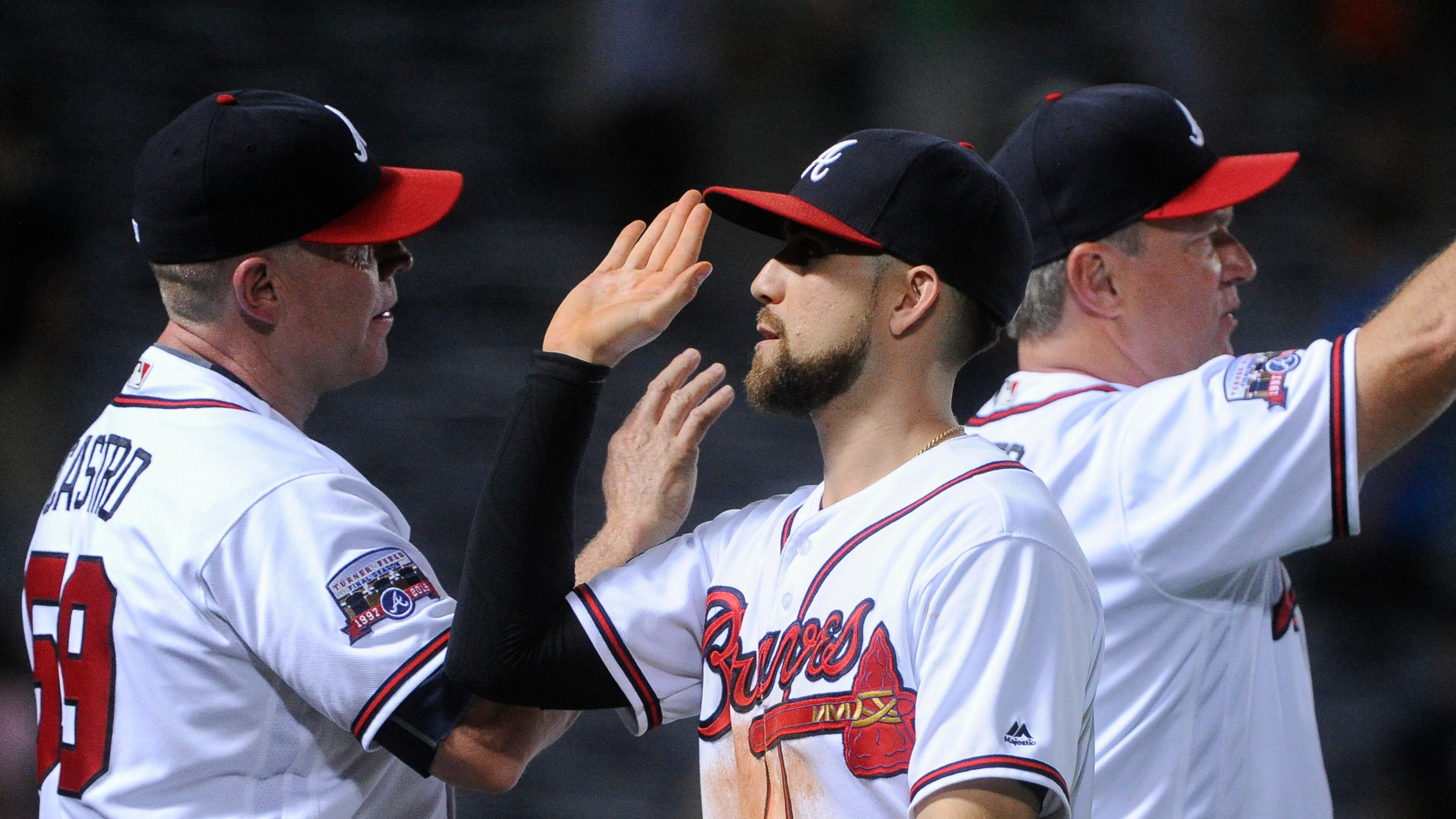 Atlanta Braves' Ender Inciarte, center celebrates with assistant hitting coach Jose Castro, left, as he comes off the field after a baseball game against the San Diego Padres, Wednesday, Aug. 31, 2016, in Atlanta. Atlanta won 8-1. (AP Photo/John Amis)