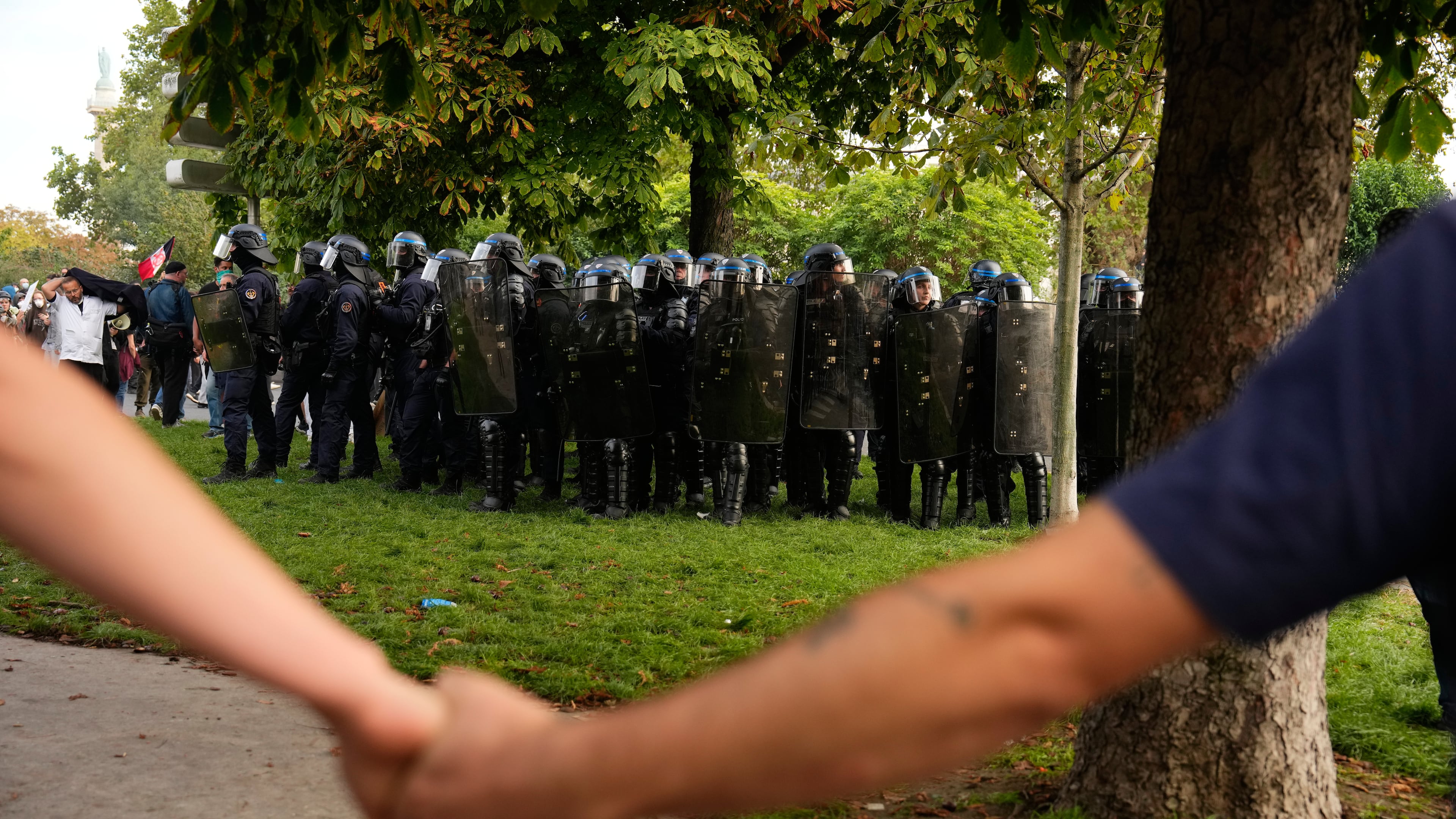 Protesters face police during a demonstration against under-resourced schools, in Paris, Tuesday, Oct. 6, 2026. (AP Photo/Teresa Suarez)