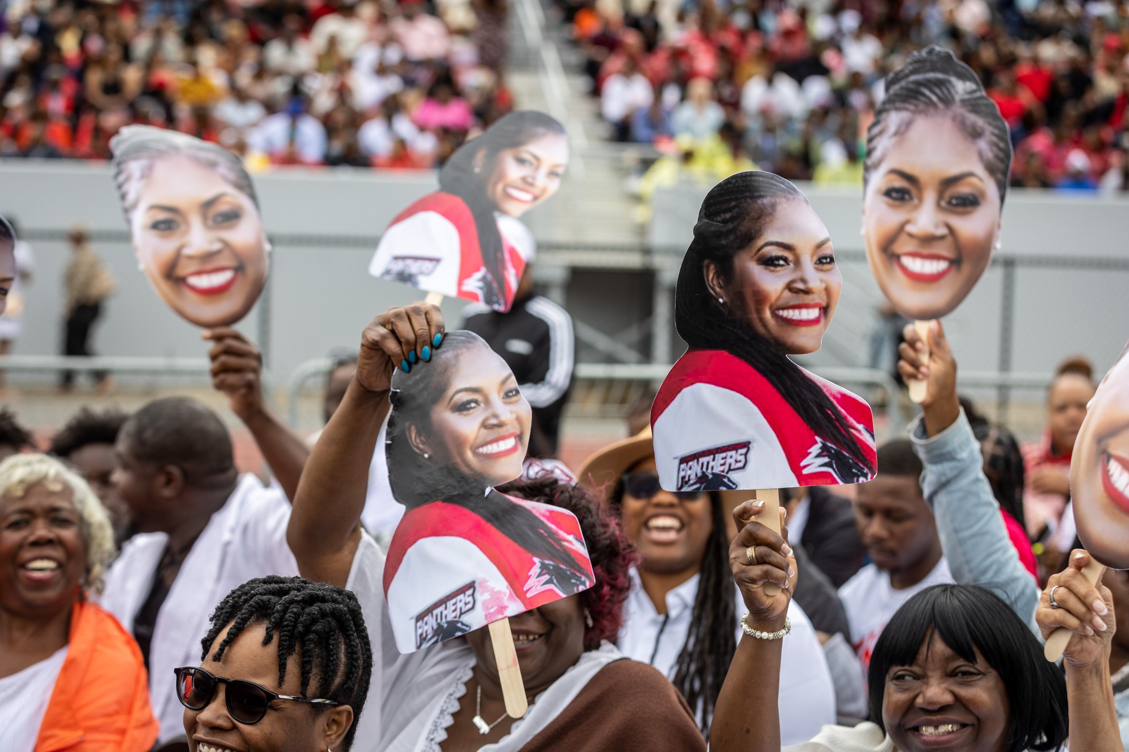 People try to get the attention of their friends and family as graduates walk into Panther Stadium for the start of Clark Atlanta University's commencement ceremony Saturday, May 20, 2023. (Steve Schaefer / steve.schaefer@ajc.com)