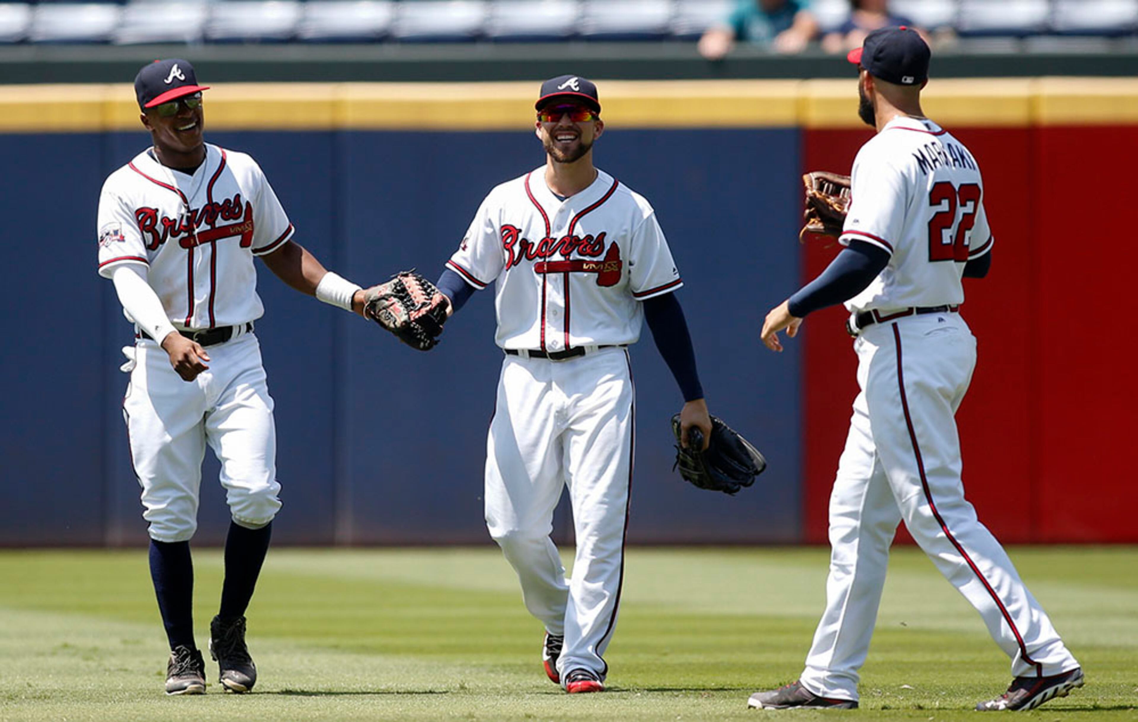 Atlanta Braves outfielders Mallex Smith (from left), Ender Inciarte and Nick Markakis celebrate a 7-2 win against the Cincinnati Reds Thursday, June 16, 2016, at Turner Field in Atlanta.