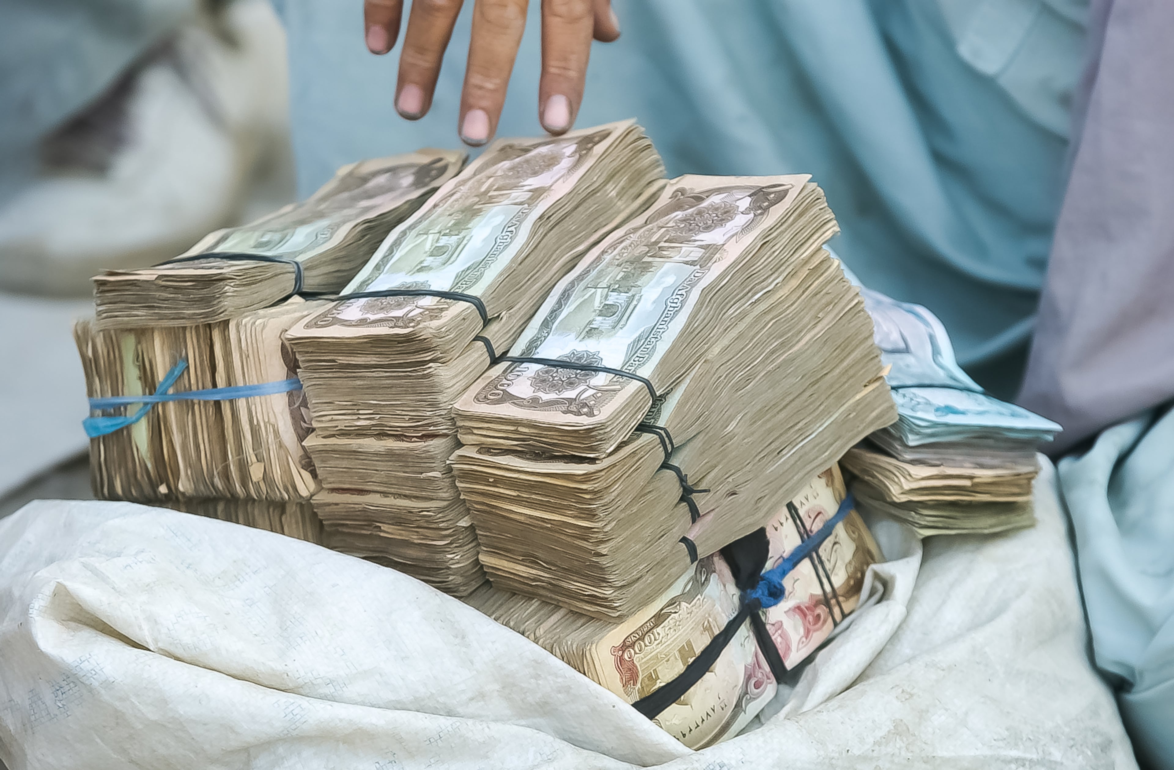 KABUL, AFGHANISTAN: A stack of Afghani bills at a money changer in Kabul's main bazaar Sunday, Sept. 8, 2002. At the time, one U.S. dollar equaled about 40,000 Afghanis, but the rate fluctuated greatly day-to-day. (Bita Honarvar / The Atlanta Journal-Constitution)