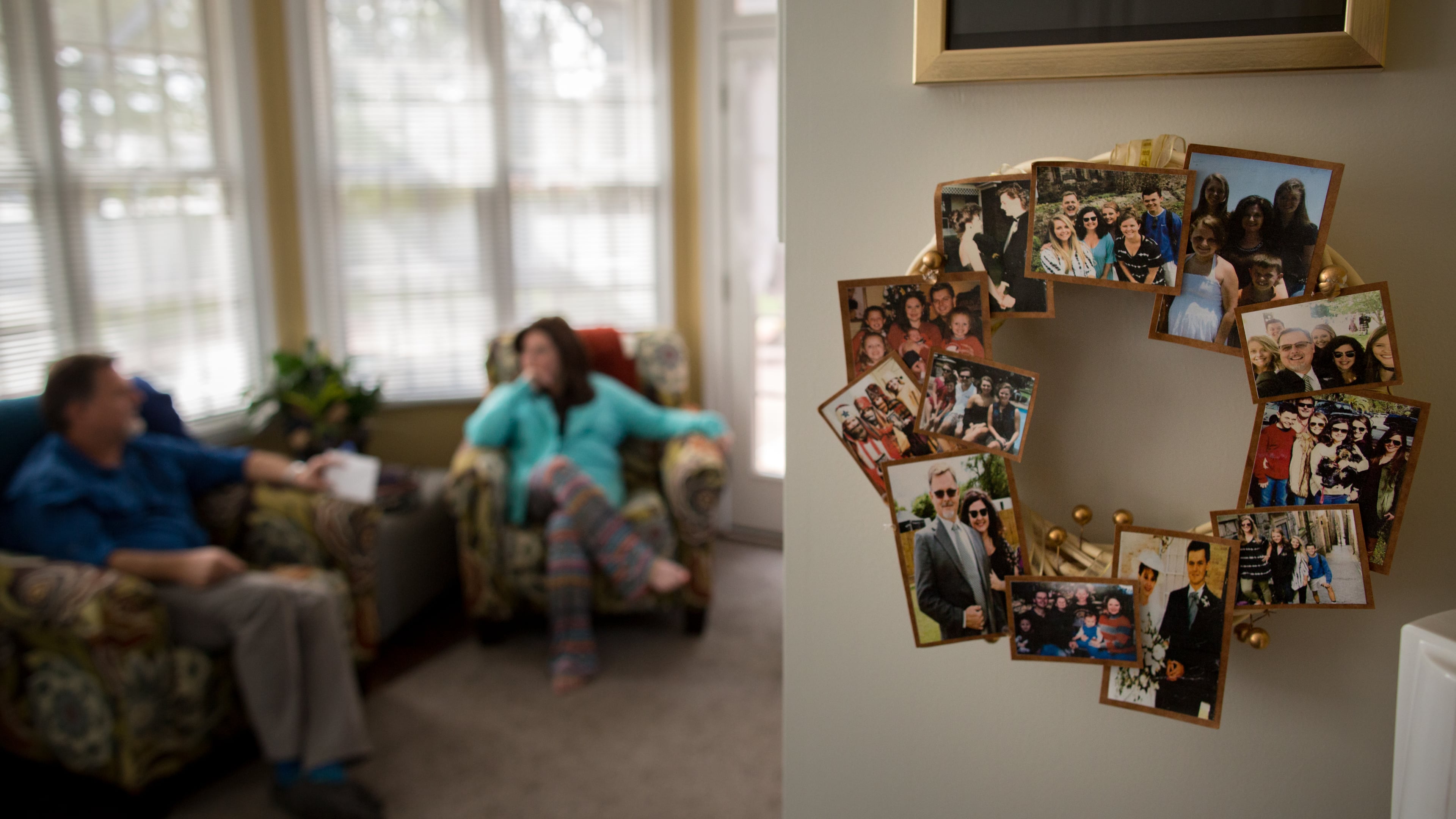 Lisa Martin's family is celebrated with a collage of photos near where she and her husband, Jeff, spend most of their time together in their home in Blackshear, Ga. Martin spent 59 days on a ventilator, battling a disease that has killed more than 550,000 people in American. (AJC Photo/Stephen B. Morton)