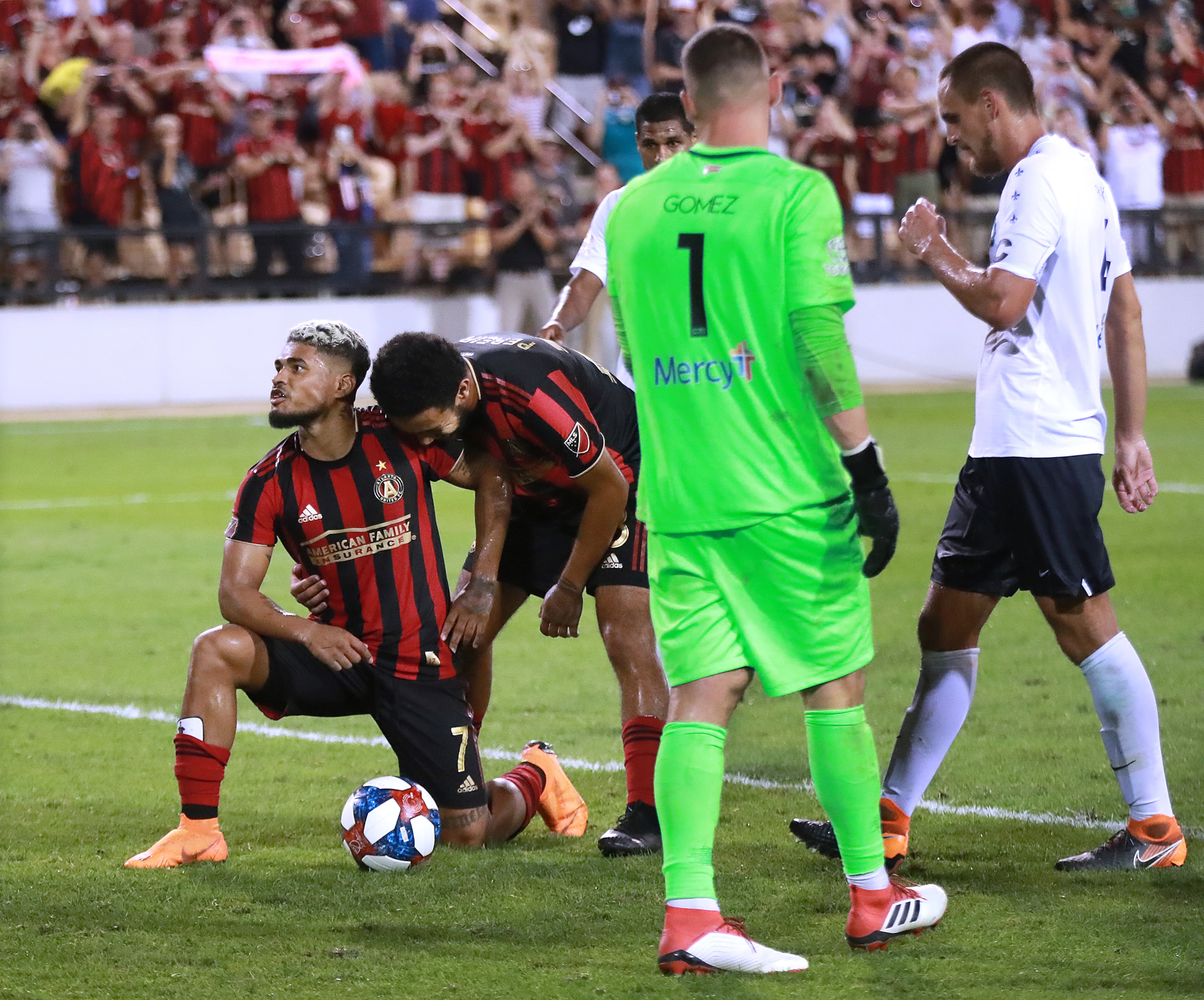 Atlanta United forward Josef Martinez (left) celebrates his penalty kick during stoppage with Dion Pereira as St. Louis goalkeeper Tomas Gomez and his teammates react. Curtis Compton/ccompton@ajc.com