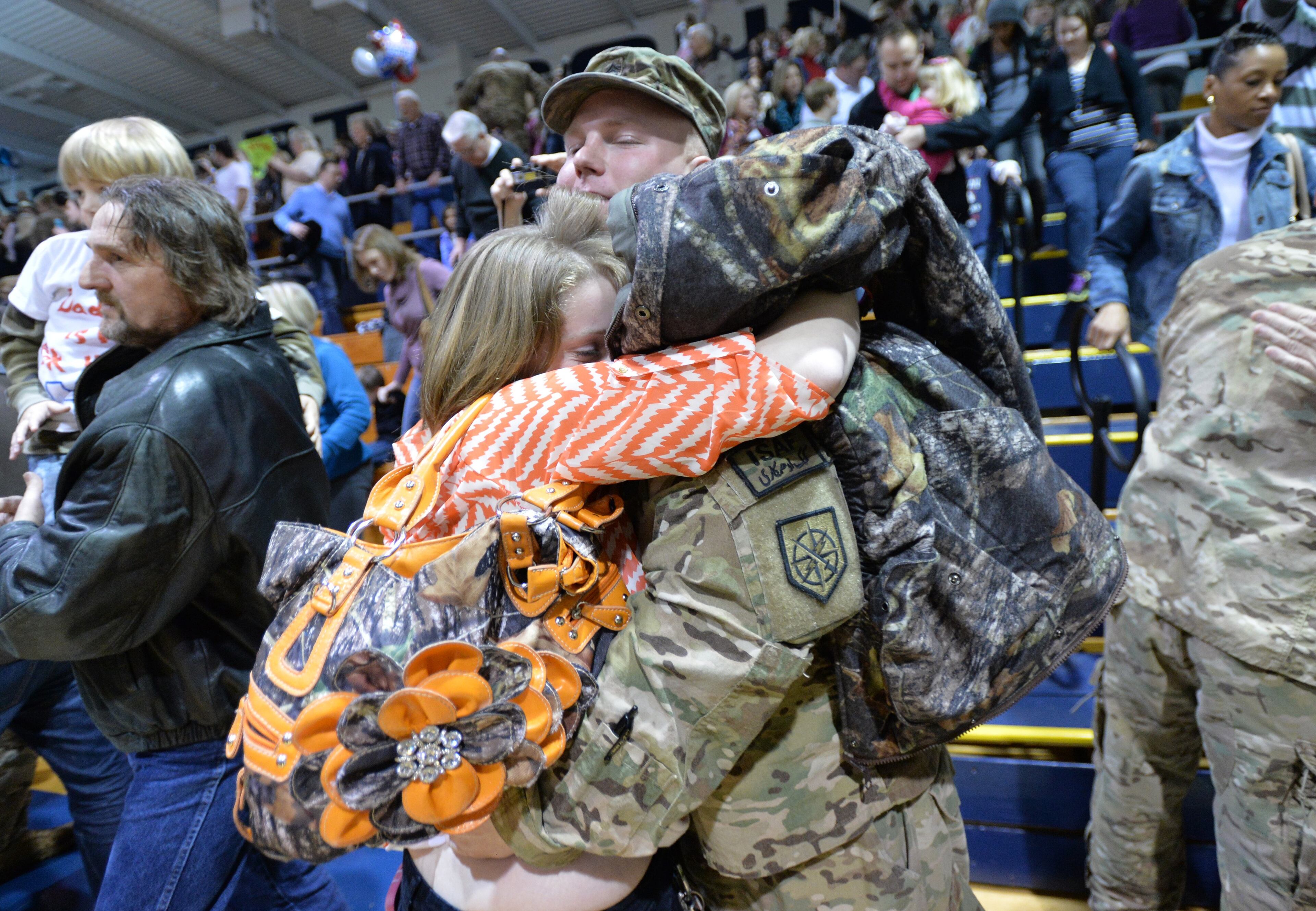 Soldiers are welcome by their family members after nearly a year deployment in Afghanistan during welcoming home ceremony at Elbert County gym in Elberton on Saturday, Jan. 11, 2014. Georgia Army National Guard's own 648th Maneuver Enhancement Brigade is welcoming home on Saturday over 200 Guardsmen with the 1-214th Field Artillery Battalion from nearly a year in Afghanistan where they conducted base defense operations in Western Afghanistan.
