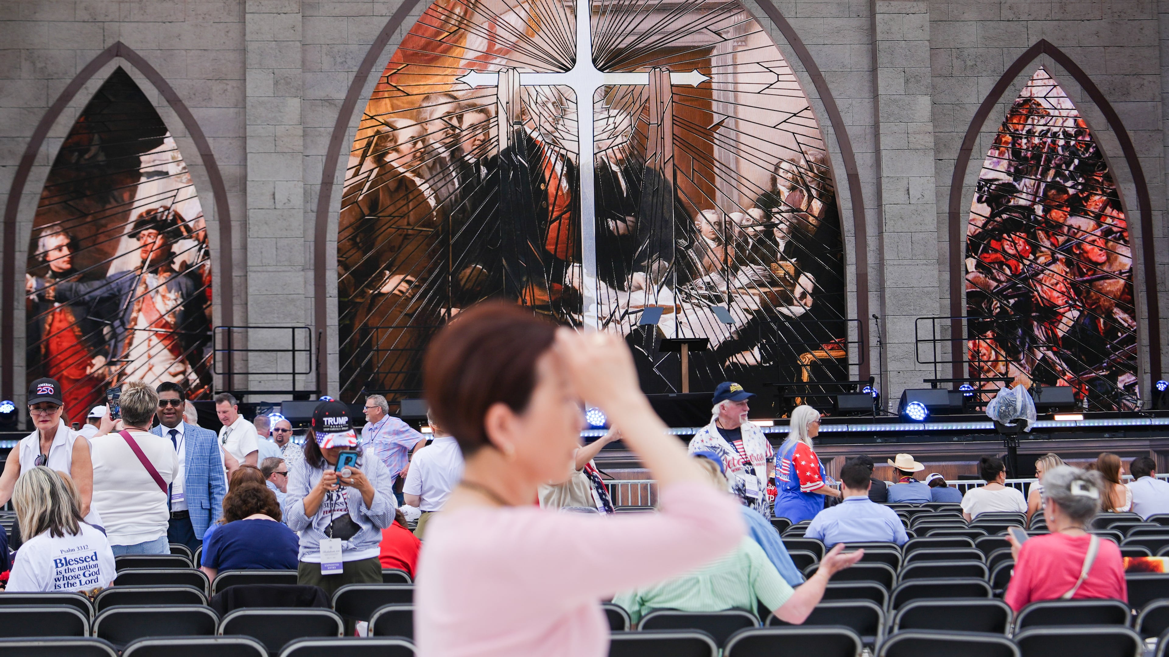 A person prays during Rededicate 250, a mostly conservative Christian prayer gathering in honor of the United States' 250th anniversary, on the National Mall, Sunday, May 17, 2026, in Washington. (AP Photo/Julia Demaree Nikhinson)