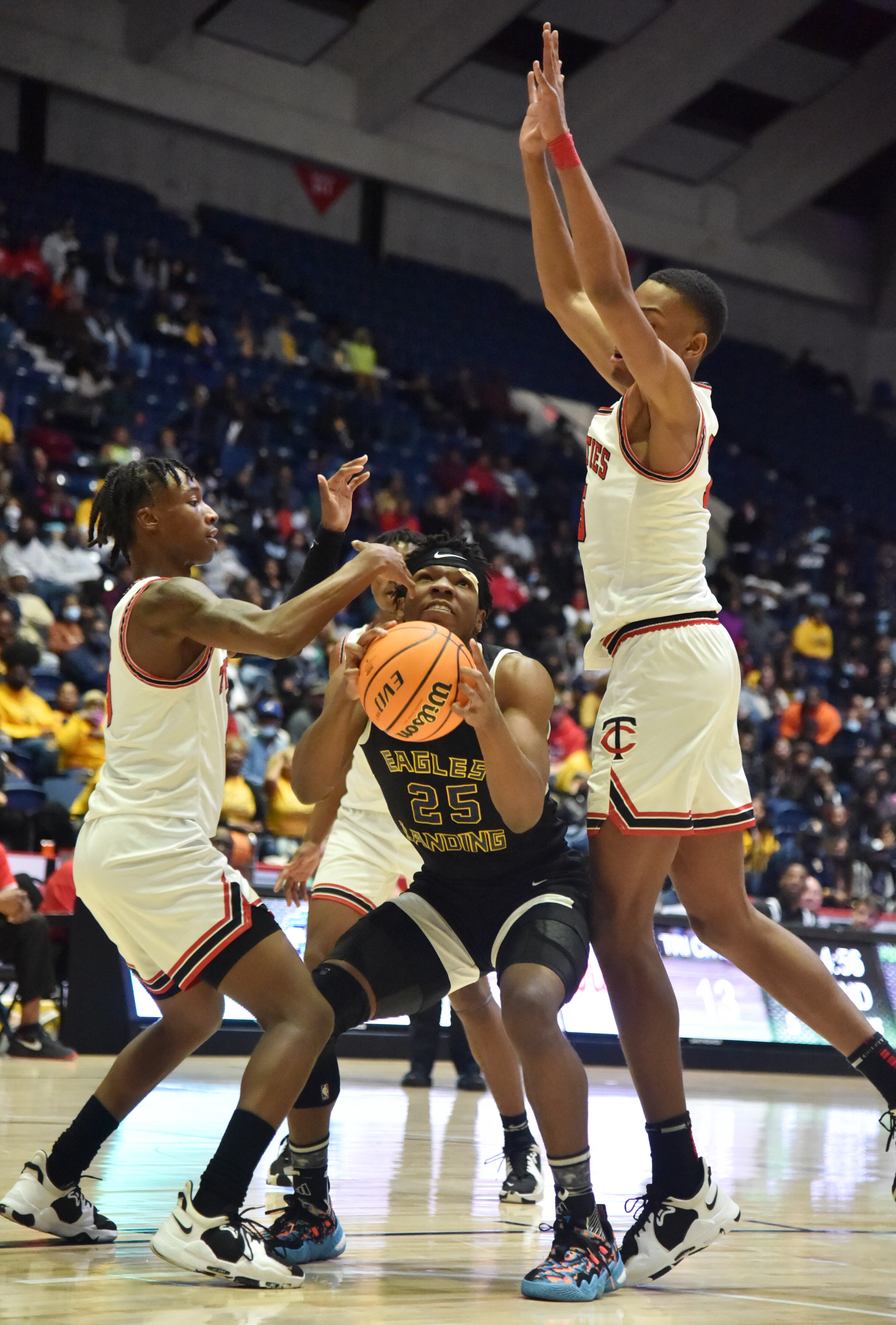 Eagle’s Landing's Jibrail Martin (25) prepares to shoot between Tri-Cities' Kyndon Wilburg (left) and William Norwood (right) during the 2022 GHSA State Basketball Class AAAAA Boys Championship game at the Macon Centreplex in Macon on Thursday, March 10, 2022. (Hyosub Shin / Hyosub.Shin@ajc.com)