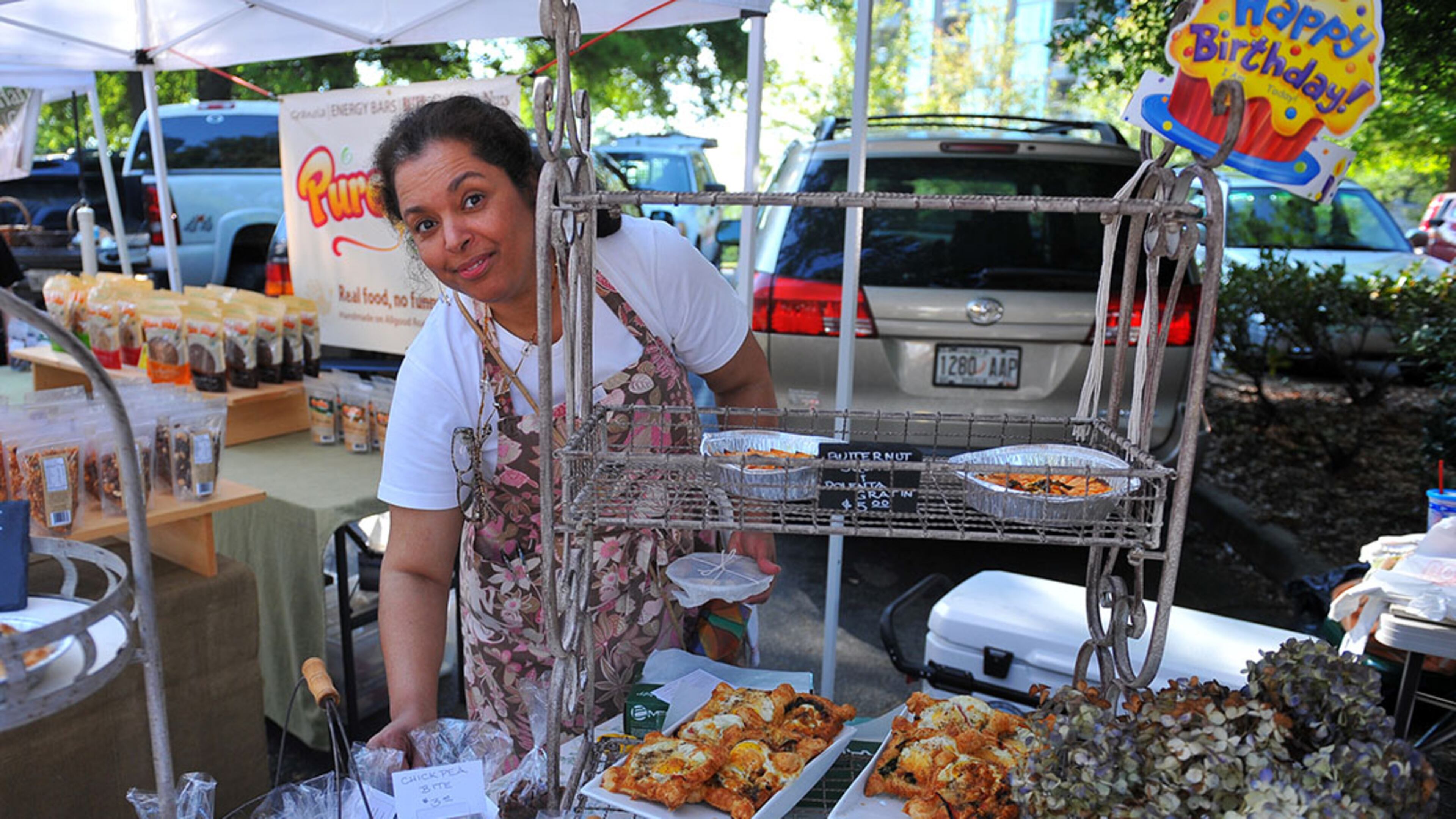 Lisa Rochon of Cuisine offers strawberry and thyme infused spring water at her stand at the Peachtree Road Farmers Market.
