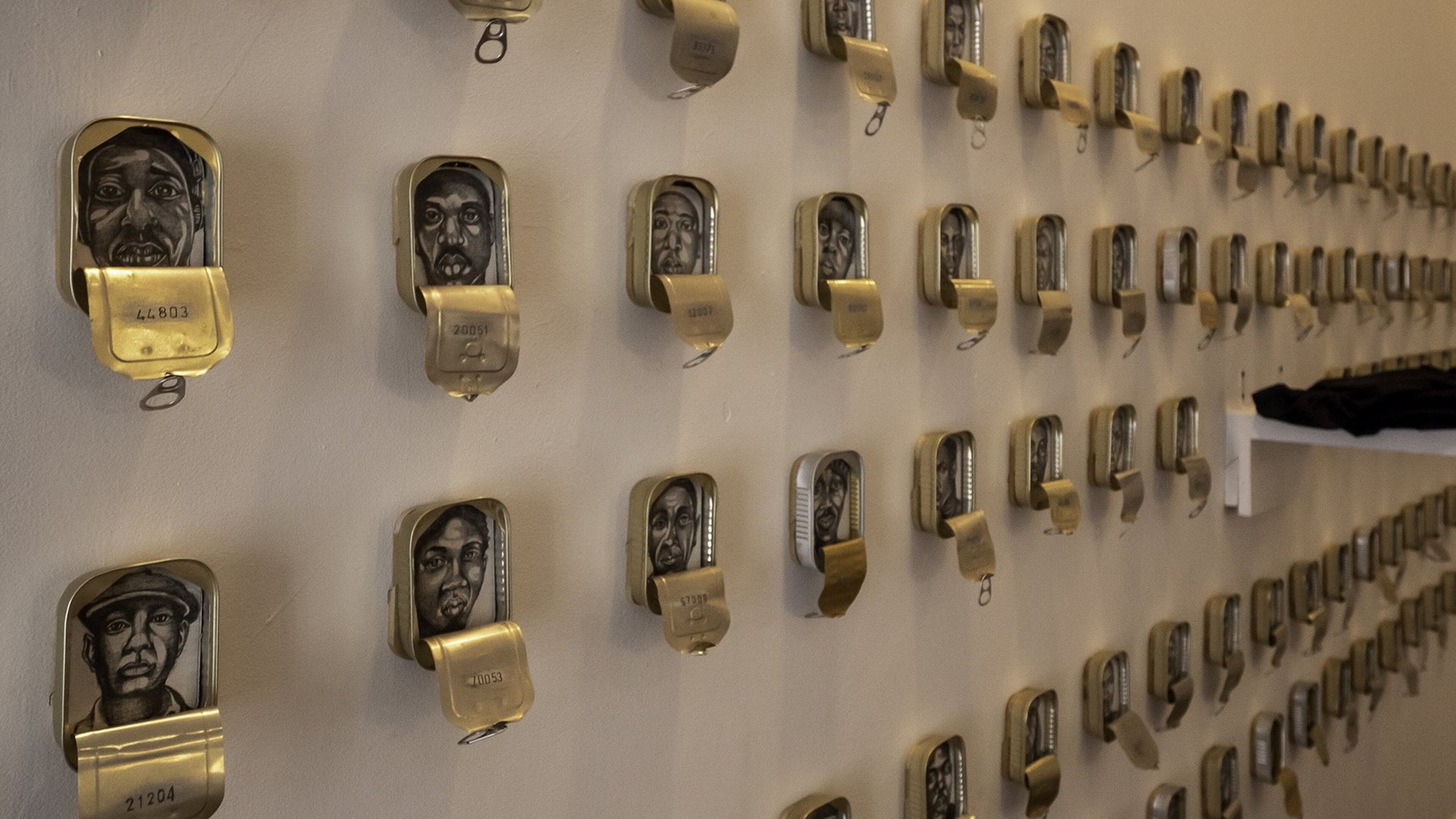 Tight Packers/Photo caption: Atlanta artist Masud Olufani’s “Translocation & Transfiguration” exhibition at Hammonds House Museum examines the idea of blackness in works like “Tight Packers.” Photo credit: Michael Moss