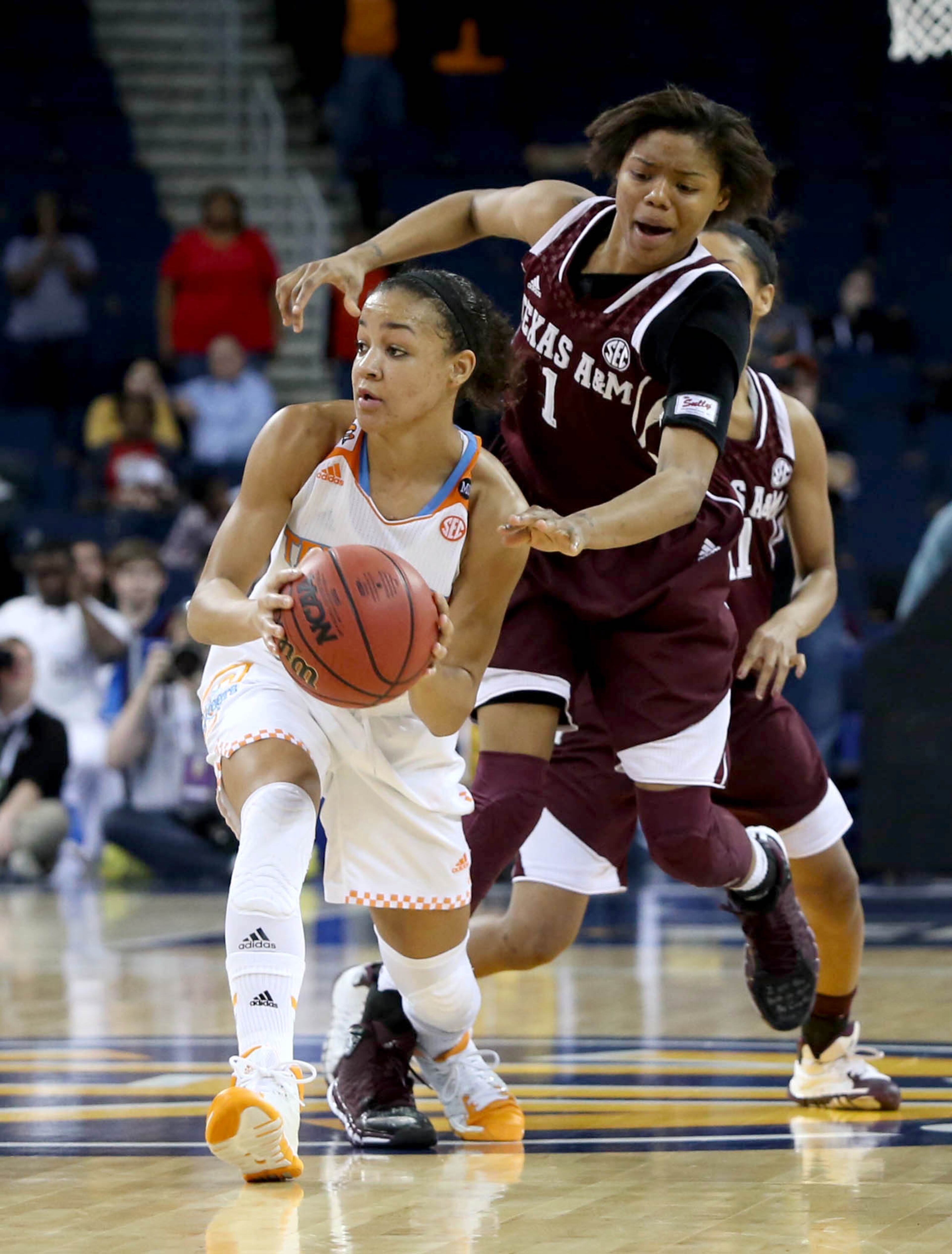 Texas A&M guard/forward Courtney Williams (1) defends Tennessee guard Andraya Carter (14) during Tennessee's win over Texas A&M in the fourth-round of the Women's Southeastern Conference NCAA college basketball game, Saturday, March 8, 2014. (AP Photo/Jason Getz)