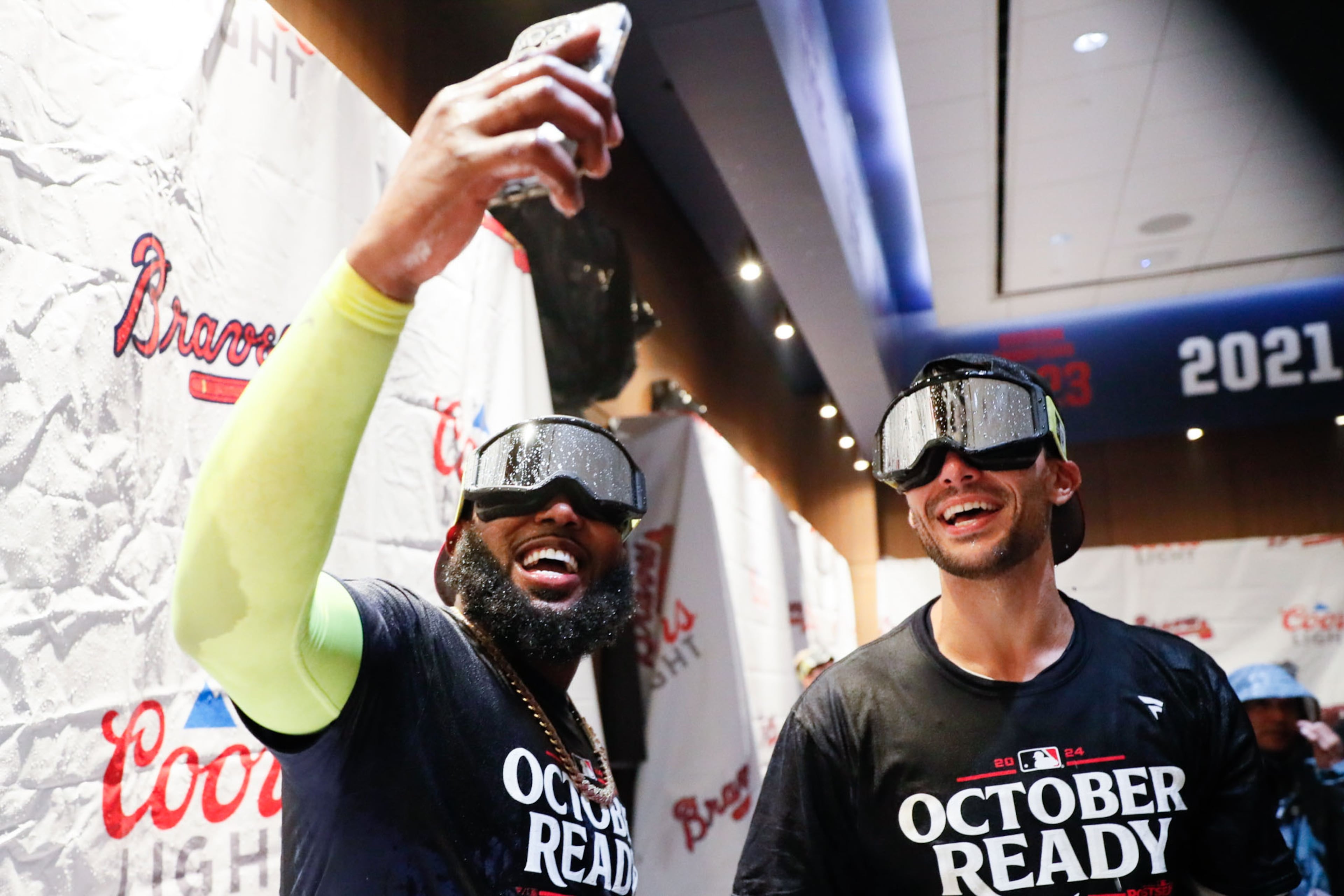 Marcell Ozuna (20) takes a selfie with Matt Olson (28) in the locker room after their 3-0 win over the Mets.
(Miguel Martinez/ AJC)
