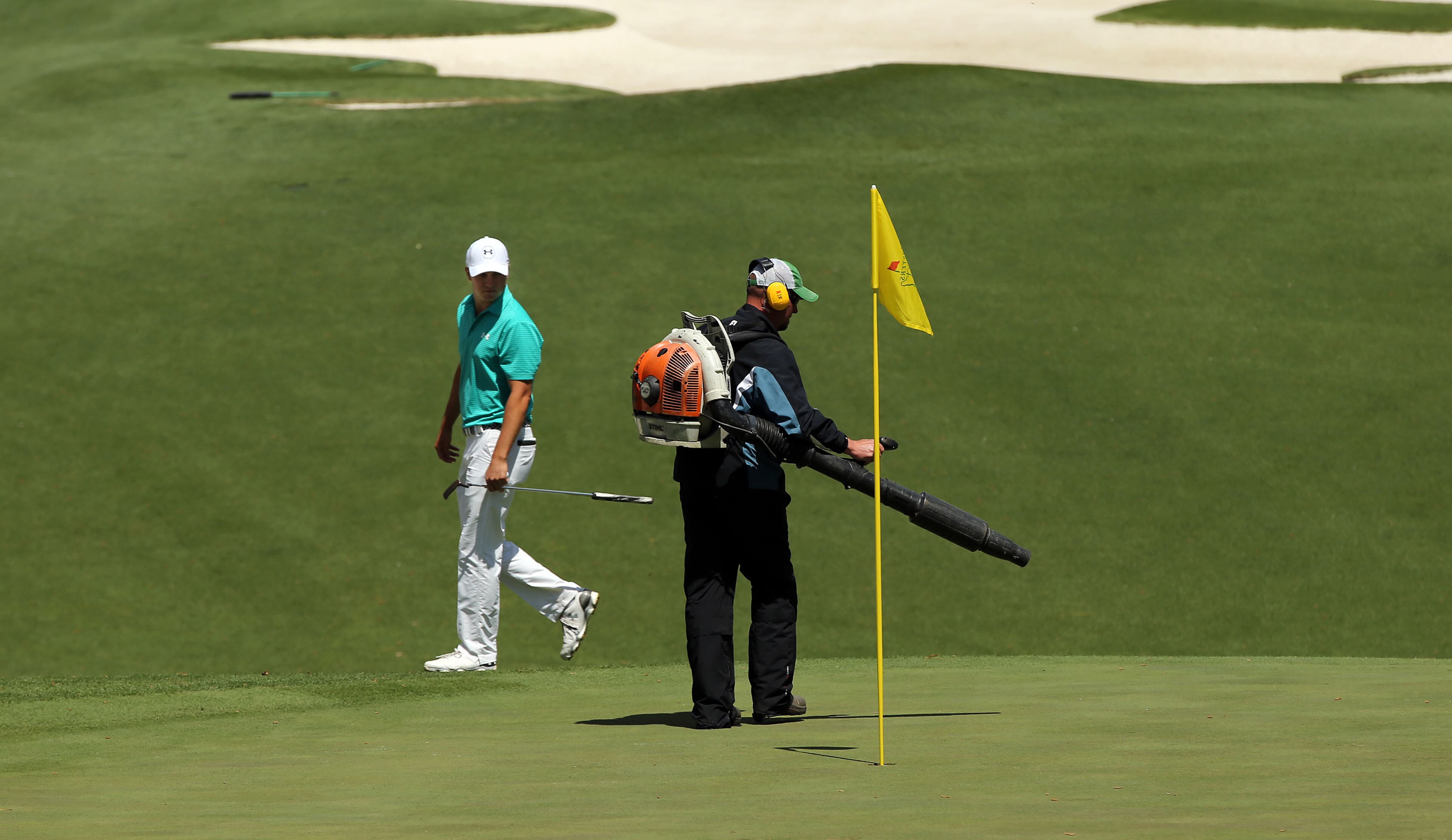 APRIL 7, 2016 AUGUSTA Jordan Spieth waits for grounds crew to clear the tenth green. Photos from the first round of the Masters Golf Tournament, at the Augusta National Golf Club, Thursday, April 7, 2016. CURTIS COMPTON/CCOMPTON@AJC.COM