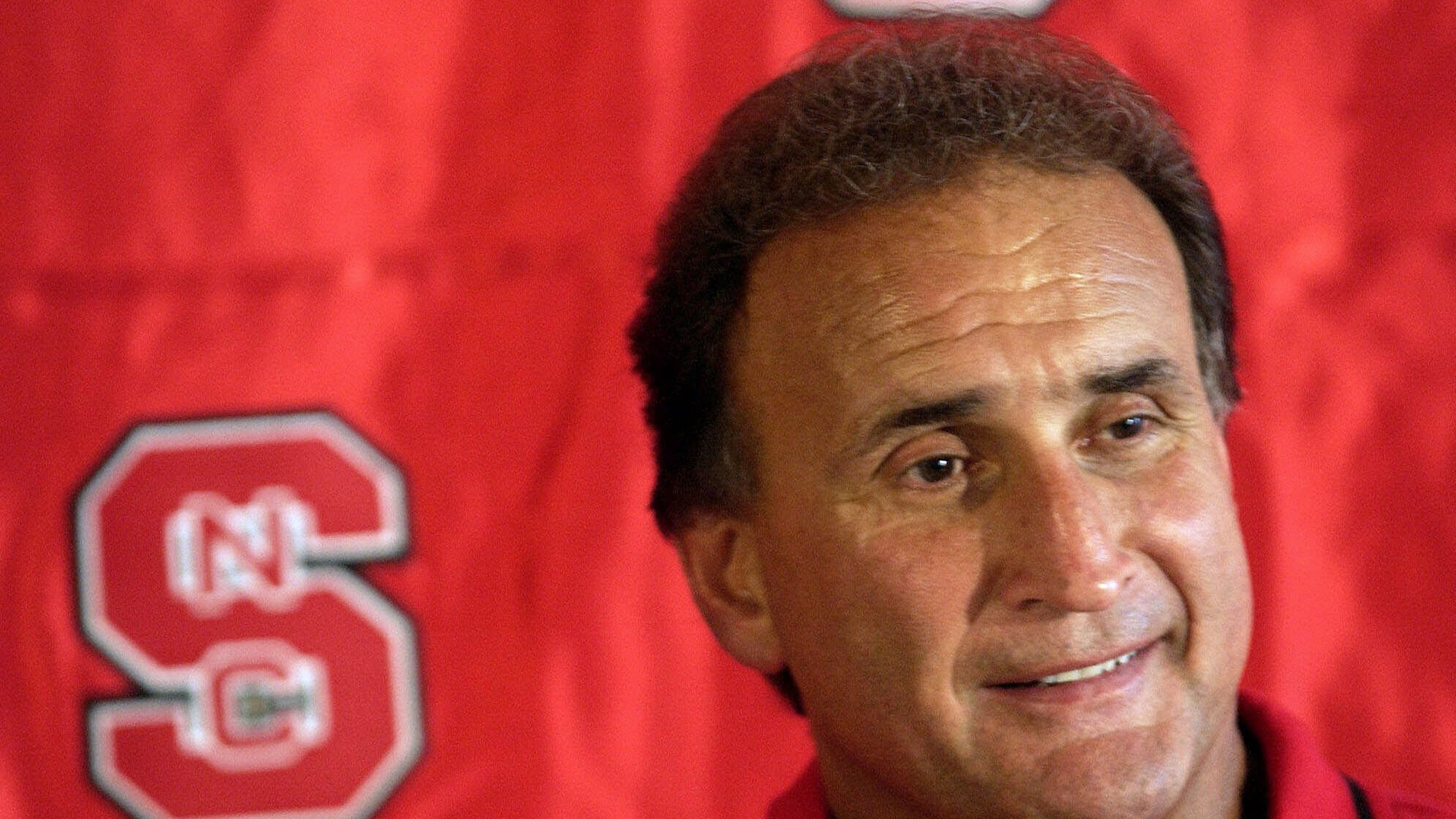FILE - North Carolina State coach Chuck Amato answers questions from reporters during the team's media day, Aug. 12, 2001, at Carter-Finley Stadium in Raleigh, N.C. (AP Photo/Grant Halverson, File)