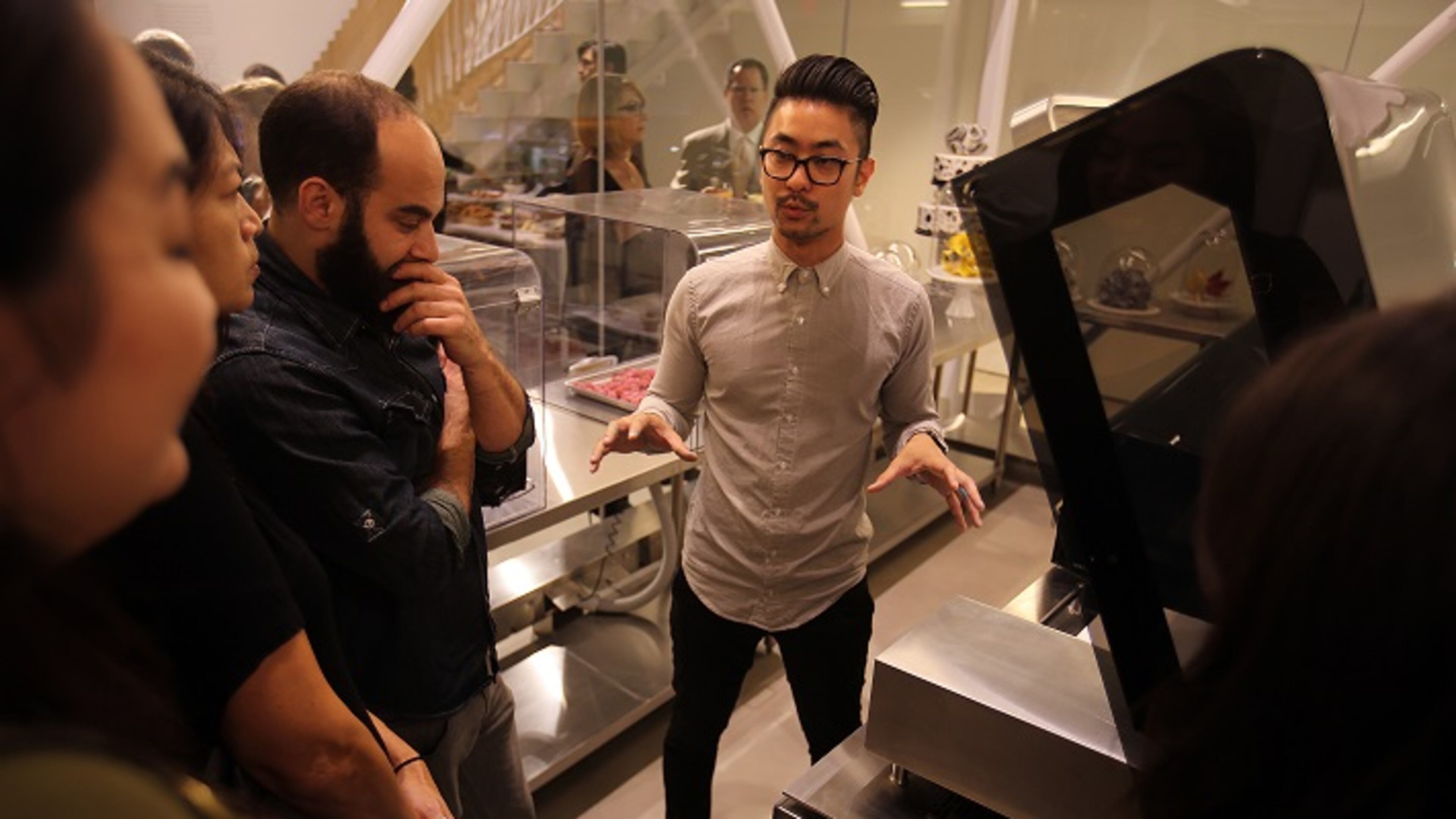 Food designer William Hu, center, explains 3D printing technology to a group of people touring the 3DS Culinary Lab on Oct. 28, 2015 in Los Angeles. (Rick Loomis/Los Angeles Times/TNS)