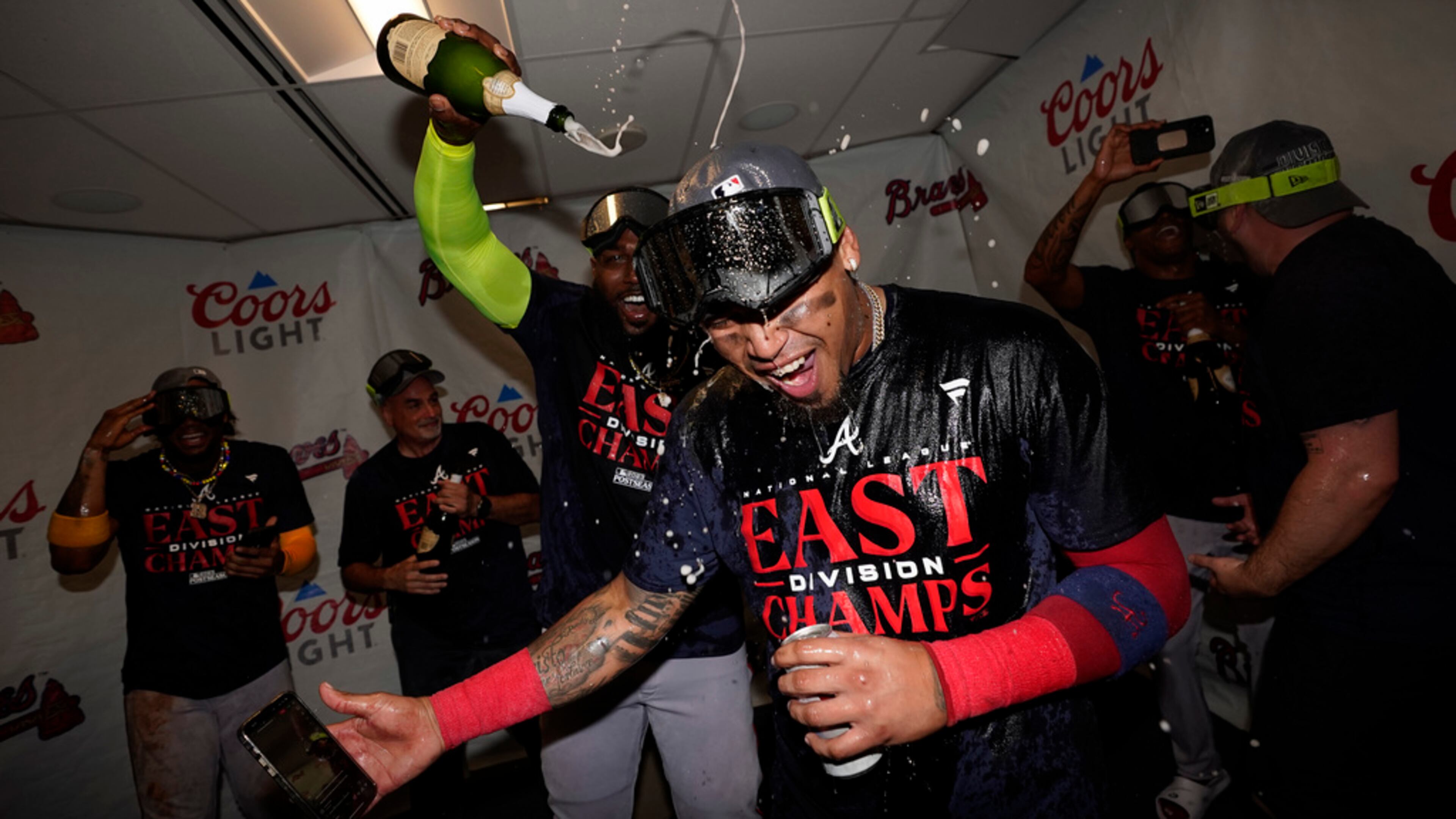 Atlanta Braves' Orlando Arcia celebrates with teammates after the Braves clinched their sixth consecutive NL East title by defeating the Philadelphia Phillies in a baseball game, Wednesday, Sept. 13, 2023, in Philadelphia. (AP Photo/Matt Slocum)