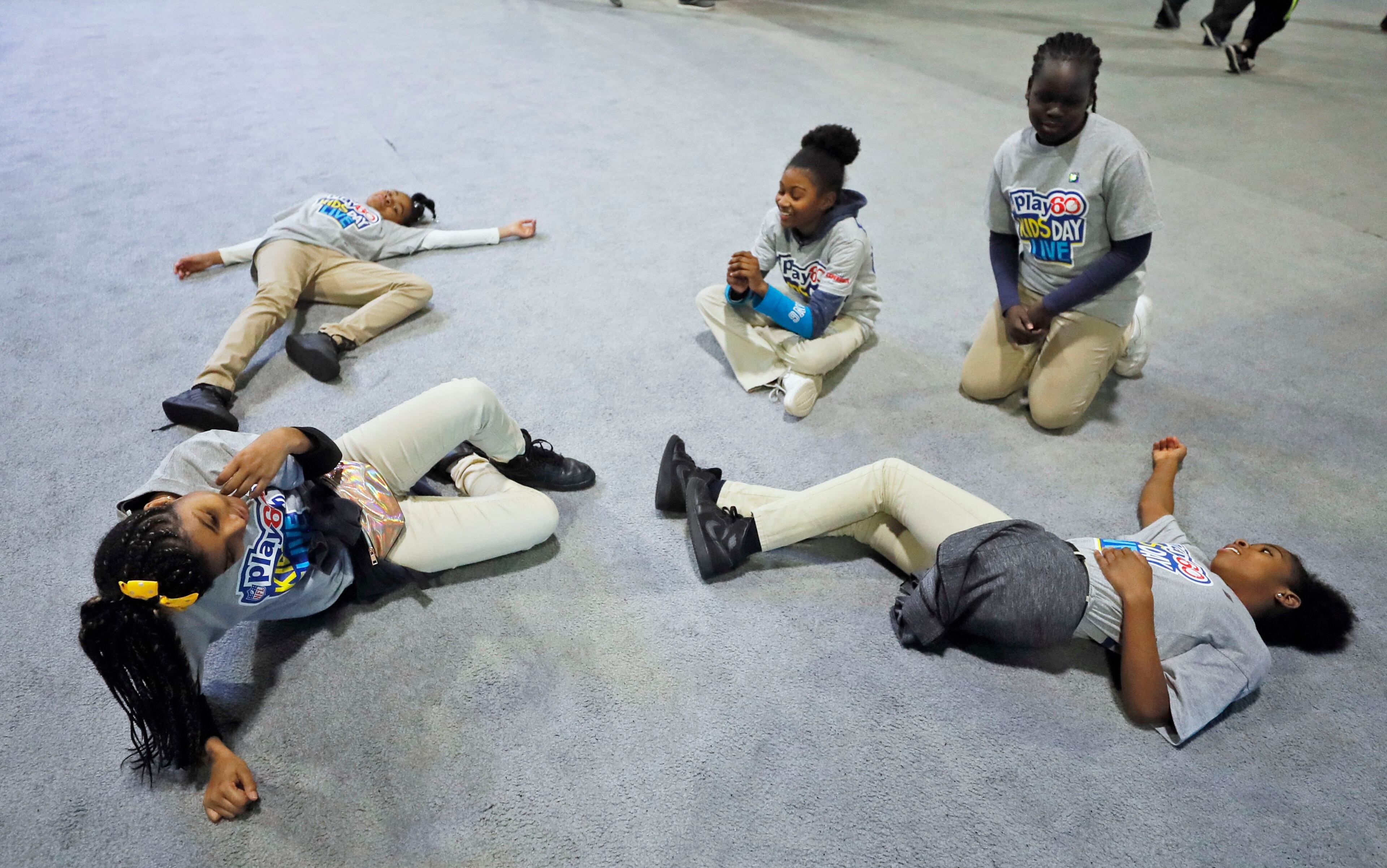 1/30/19 - Atlanta - Students from Marbut Ellementary School in Lithonia catch their breath after running in the 40 yard dash attraction. NFL PLAY 60 Kids' Day gave more than 2,000 local youth to spend the day at the Super Bowl Experience. The kids were free to roam through the many attractions at the Georgia World Congress Center. Bob Andres / bandres@ajc.com