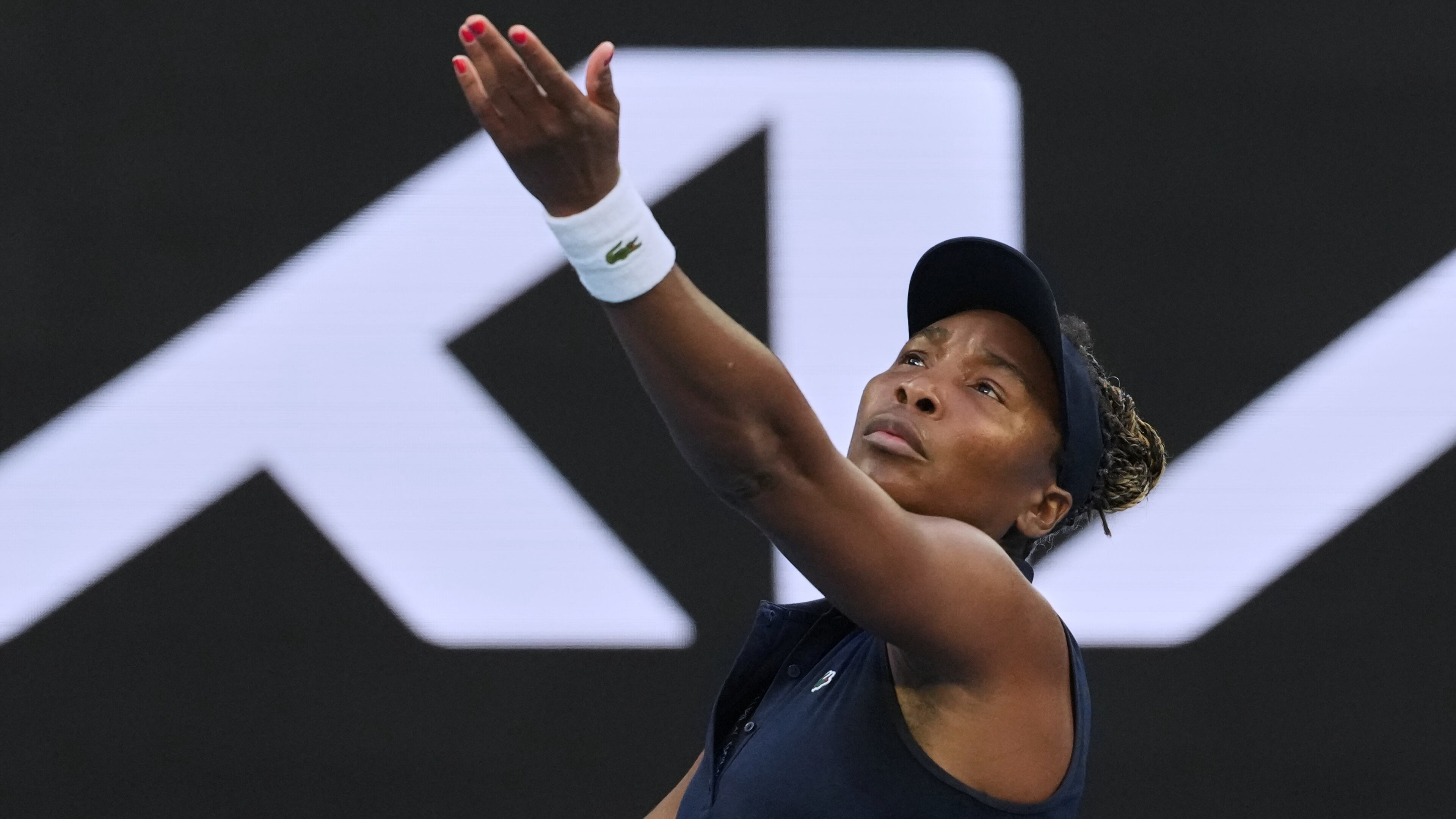 Venus Williams of the U.S. serves to Olga Danilovic of Serbia during their first round match at the Australian Open tennis championship in Melbourne, Australia, Sunday, Jan. 18, 2026. (AP Photo/Aaron Favila)