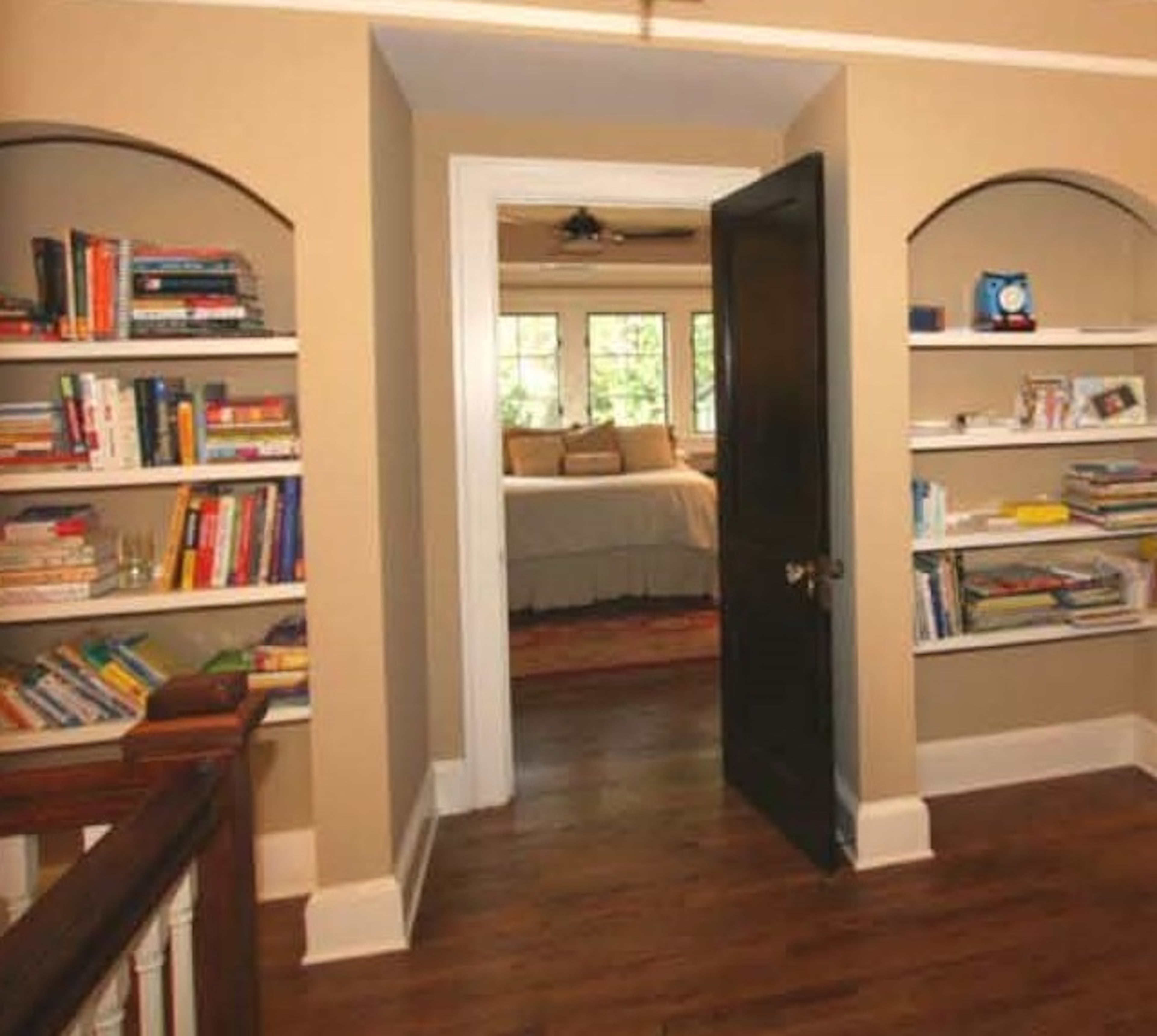 The upstairs was a new addition but needed to look original to the home. Arched bookcases, vintage light fixtures and stained glass windows were all installed to keep true to the homes era and add that desired historic character.