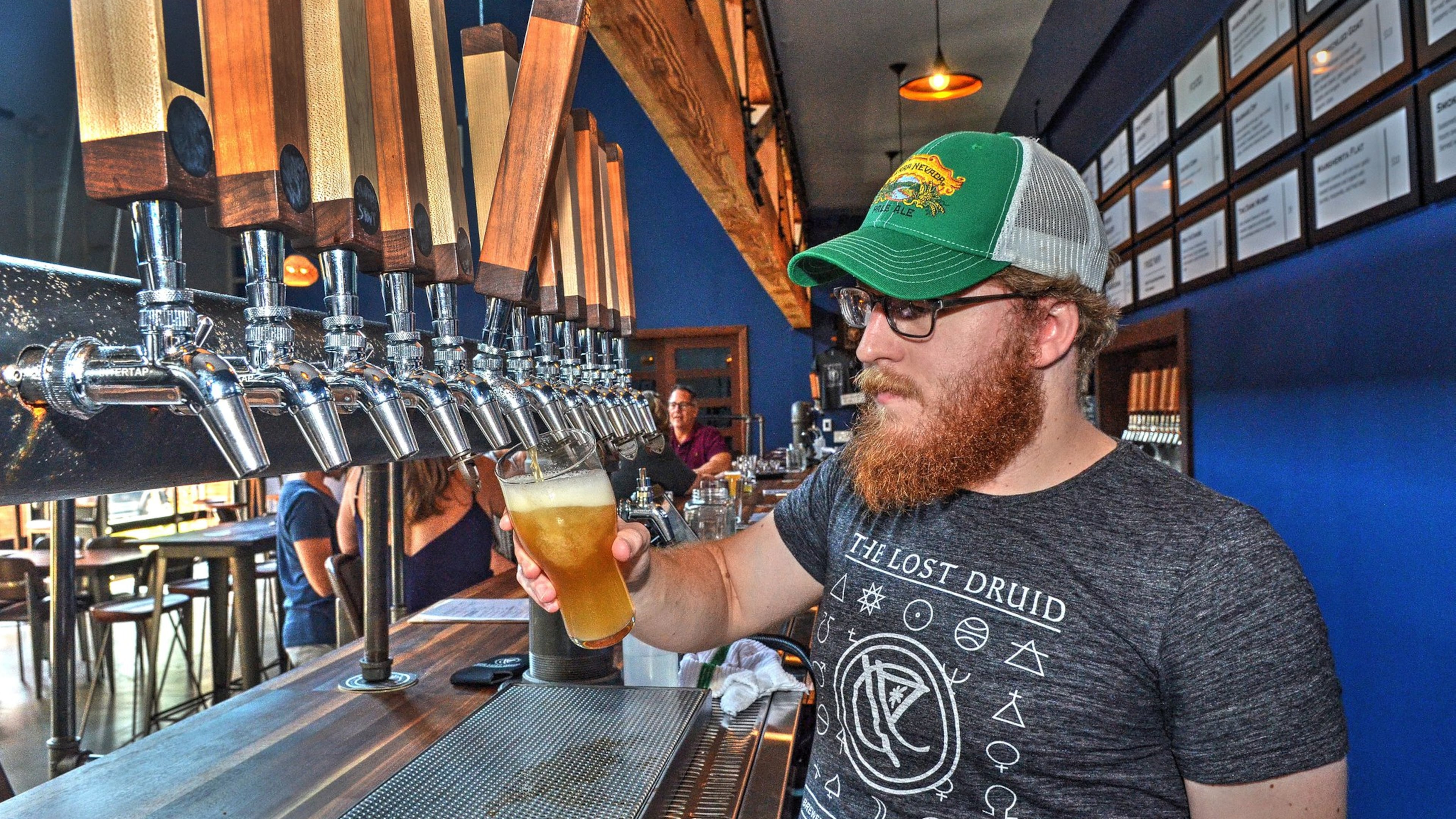 Joey Lynch, bartender at the Lost Druid Brewery, pours a Mistic Rattler, a combination of lemonade and IPA. CONTRIBUTED BY CHRIS HUNT PHOTOGRAPHY