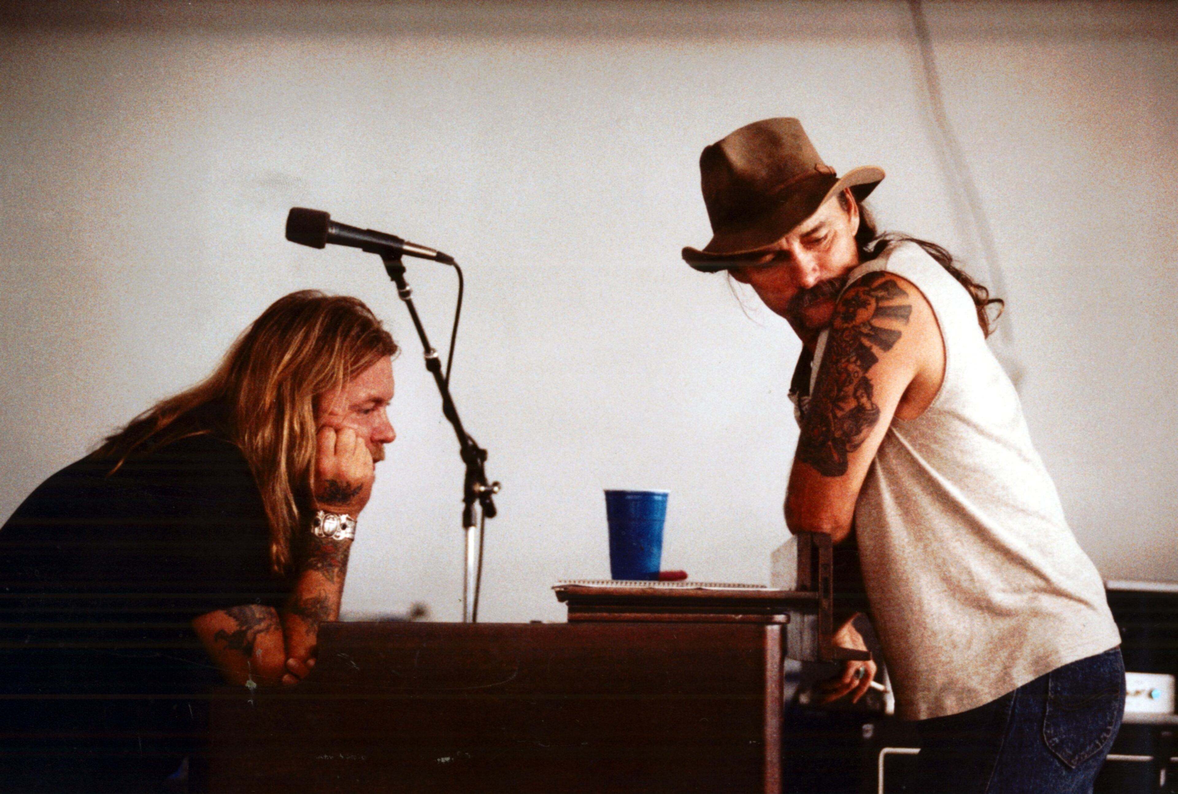 Gregg Allman (left) and Dickey Betts are lost in thought during a break in Bradenton, FL, where the Allman Brothers Band was practicing in a warehouse in preparation of their upcoming tour in 1990. (Frank Niemeir/AJC staff)