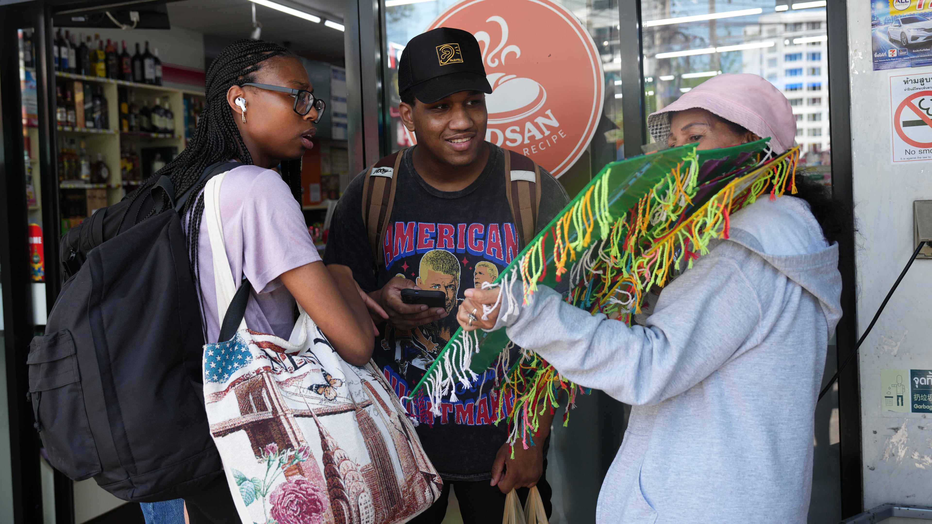 Crew members of the USS Abraham Lincoln talk to a souvenir vendor in Pattaya, Thailand, Thursday, Sept. 3, 2026. (AP Photo/Sakchai Lalit)