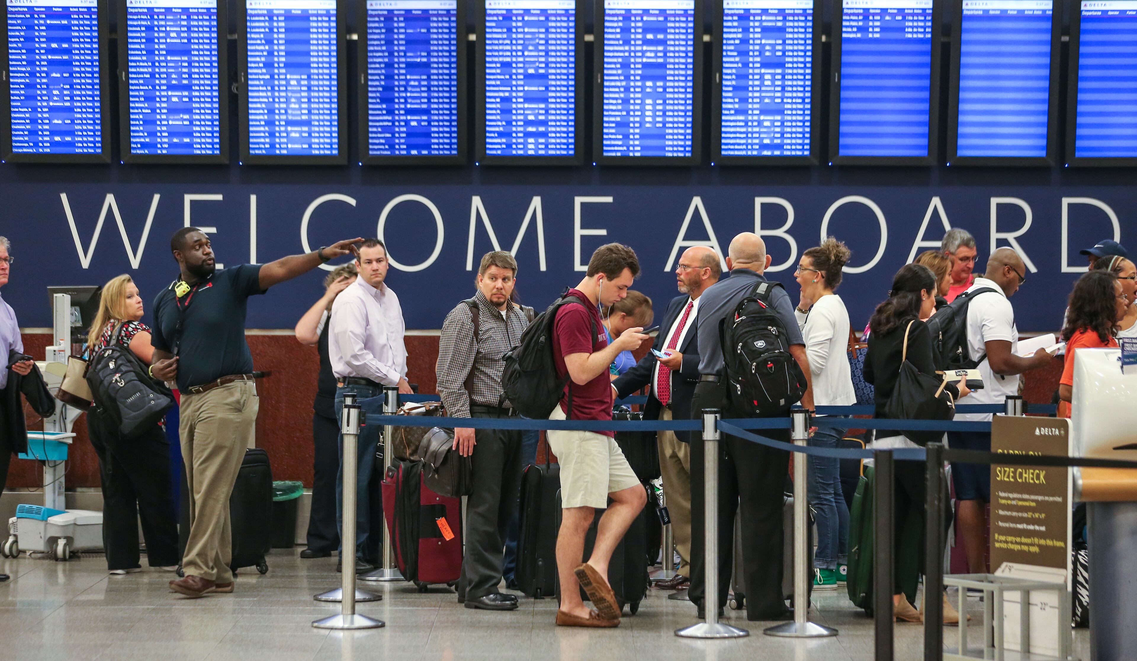 Travelers wait at Hartsfield-Jackson International Airport on Monday, Aug. 8, 2016 after a computer outage caused cancellations and delays across Delta's entire operation. JOHN SPINK /JSPINK@AJC.COM