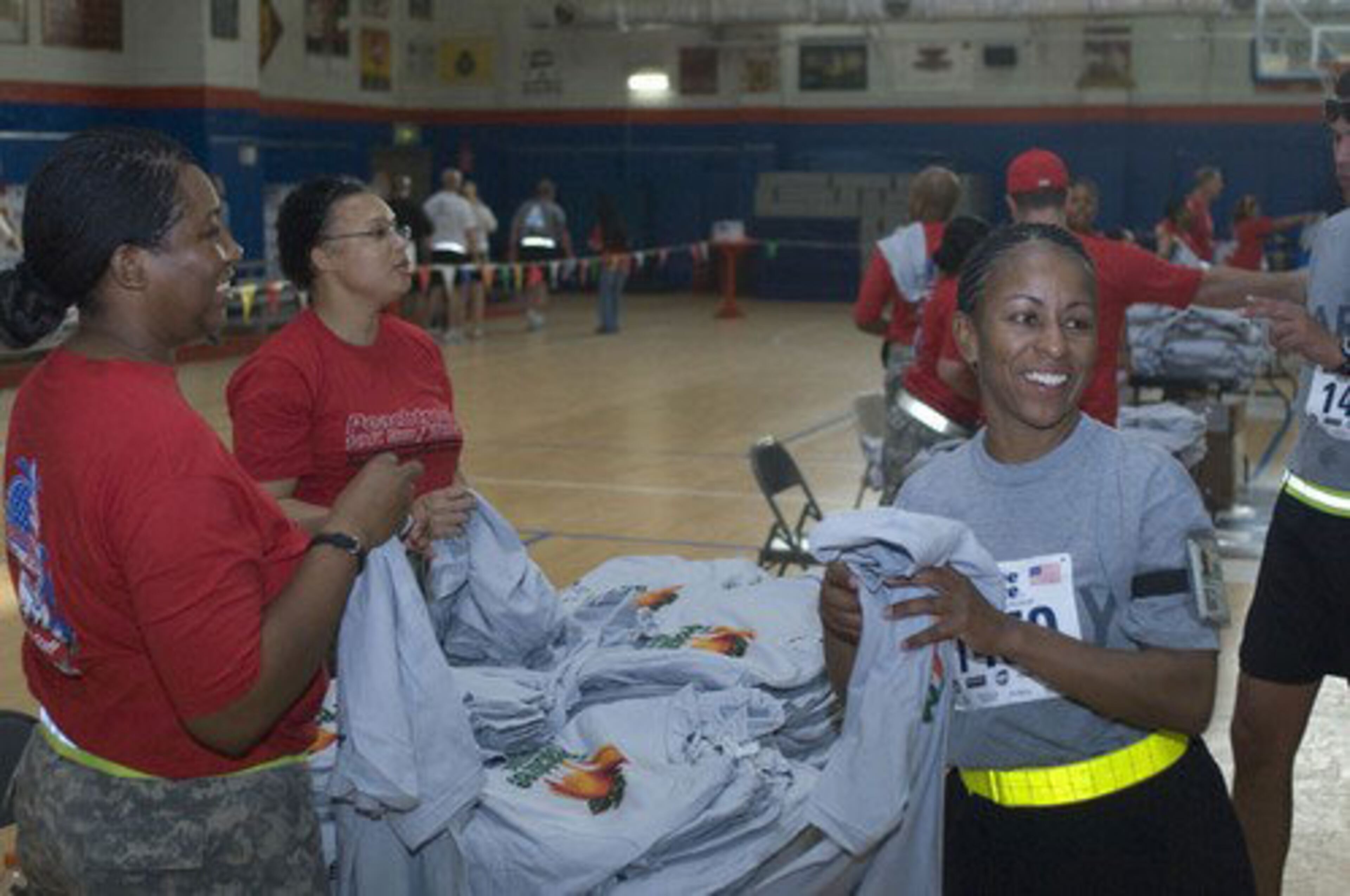 Participants are thrilled and proud to receive an Official Peachtree 10K t-shirt at the end of the run on Camp Arifjan, Kuwait.