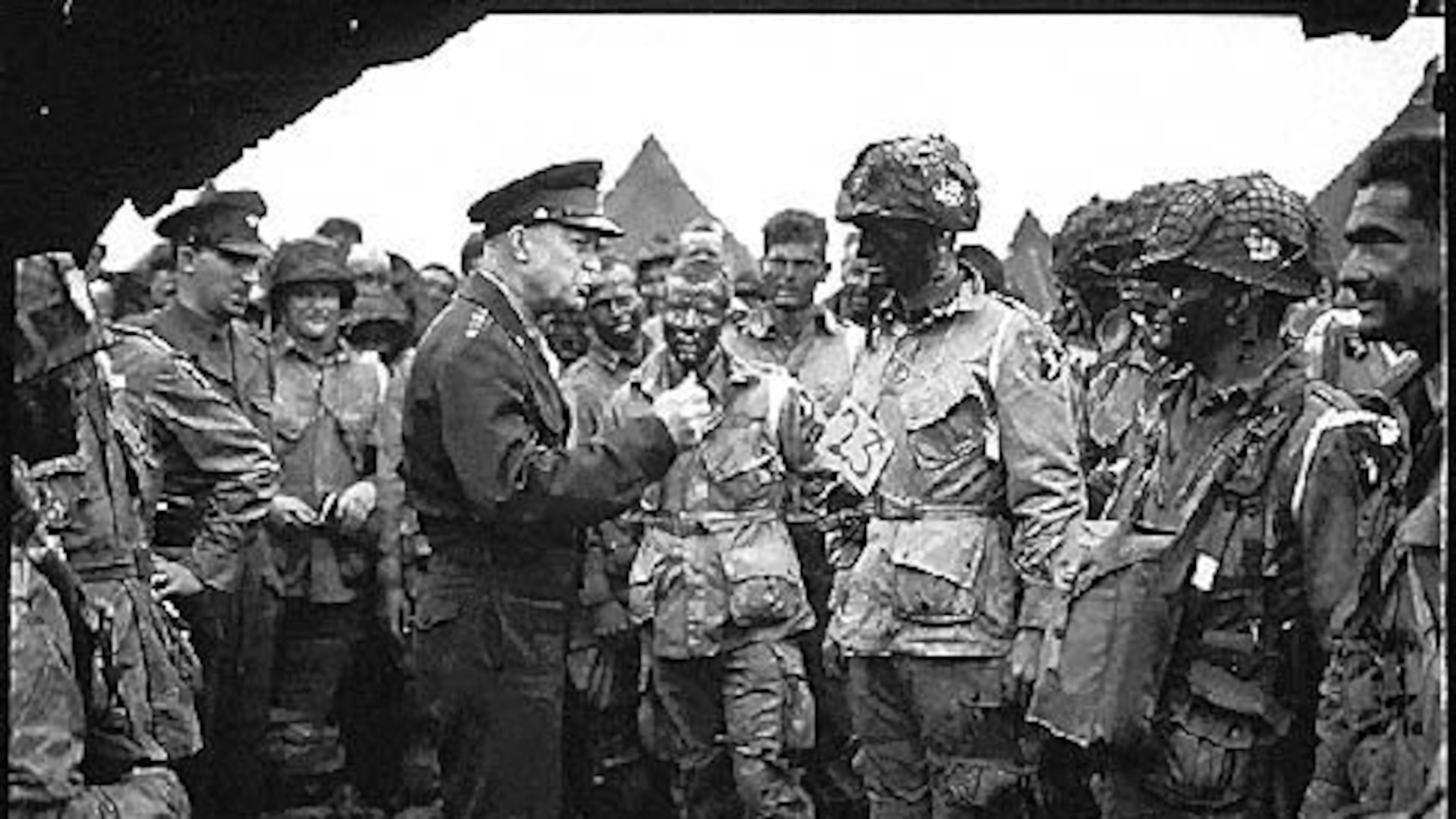 Supreme Allied Commander U.S. Army Gen. Dwight D. Eisenhower speaks with 101st Airborne Division paratroopers before they board airplanes and gliders to take part in a parachute assault into Normandy as part of the Allied Invasion of Europe, D-Day, June 6, 1944.
