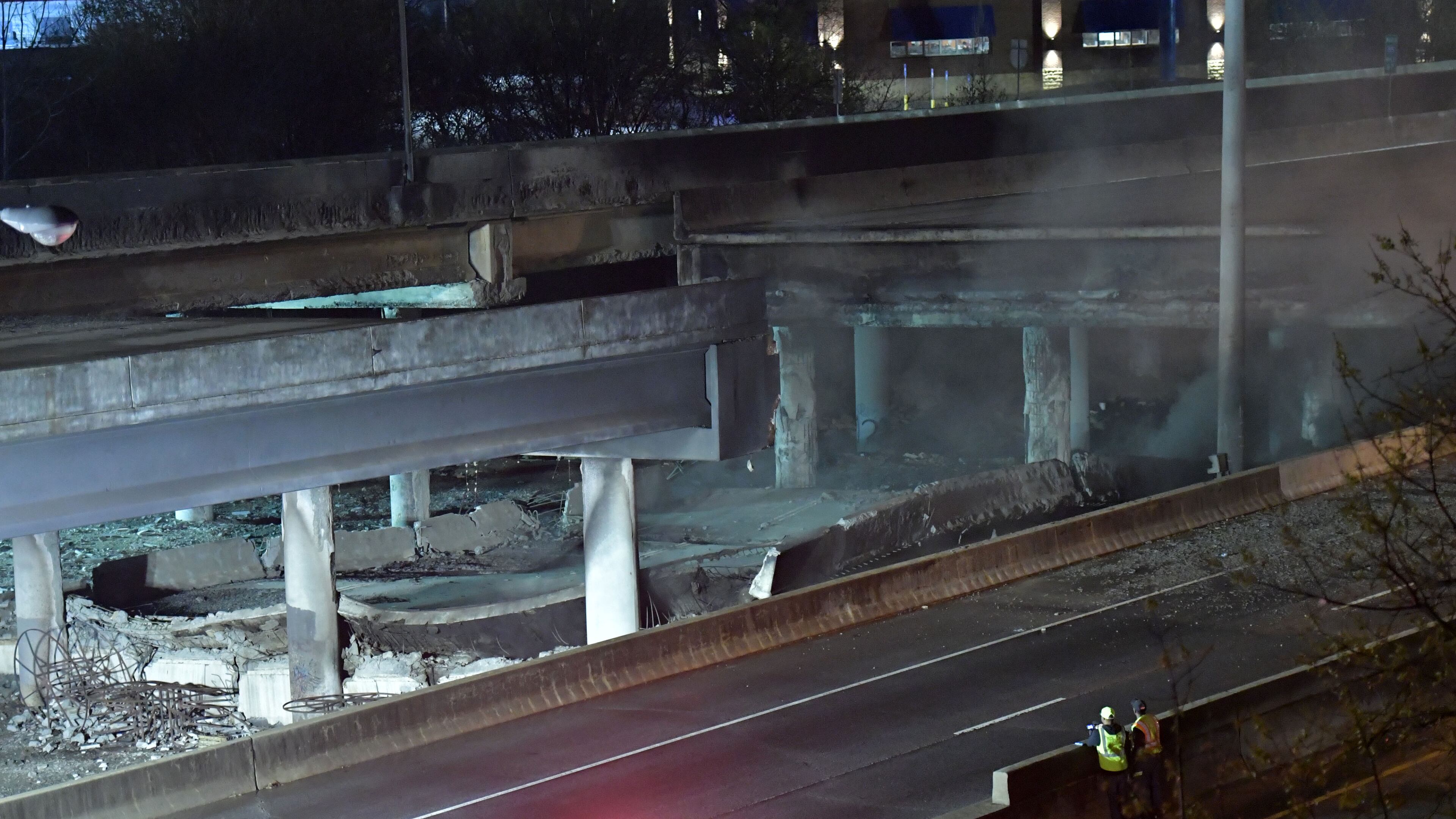 Crew surveys the section of an overpass that collapsed from a fire on I-85 on Thursday, March 30, 2017. Fire officials extinguished a massive fire on I-85 on Thursday night after it burned for more than an hour and led to the collapse of a bridge on the interstate, fire officials said. HYOSUB SHIN / HSHIN@AJC.COM