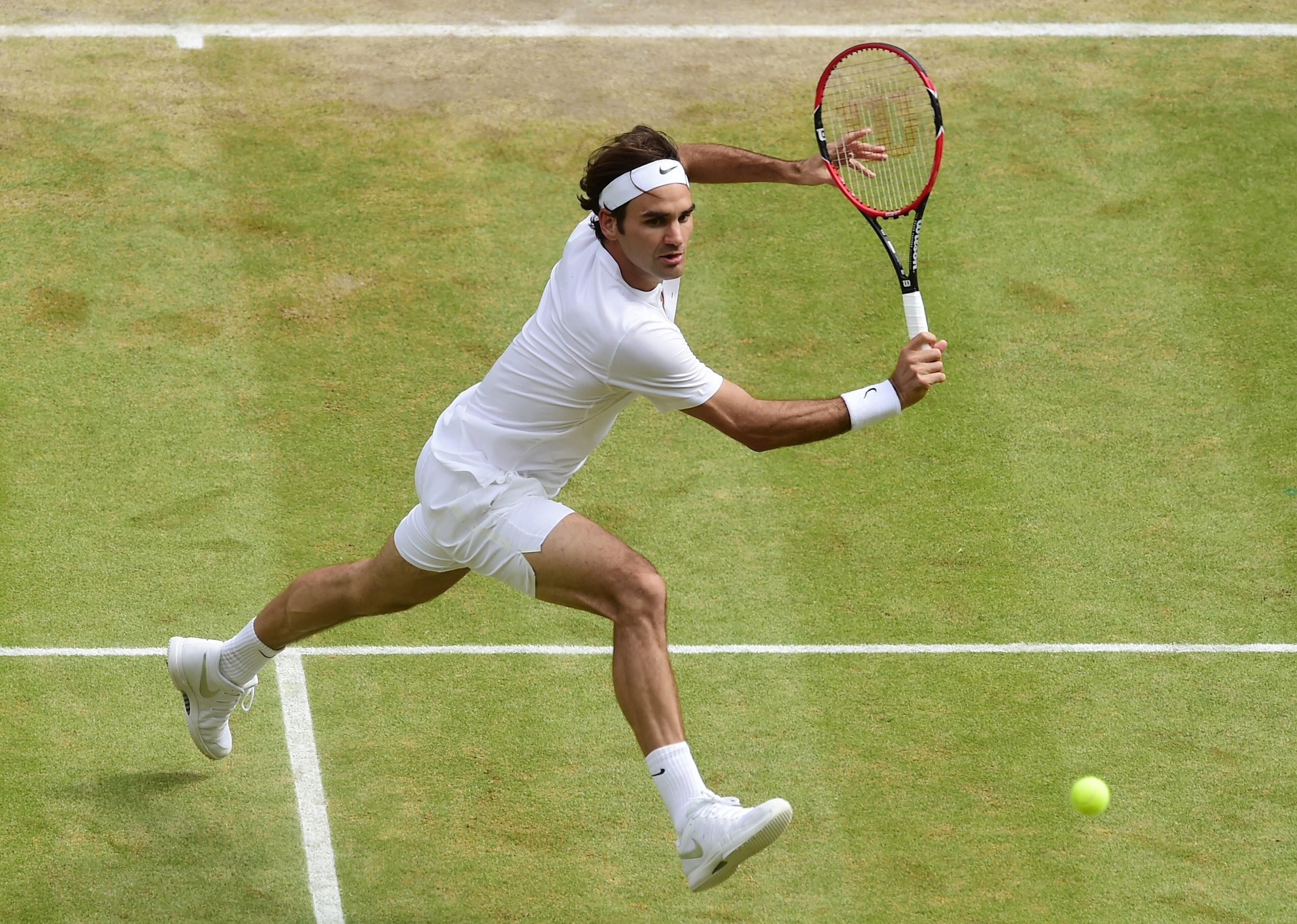 LONDON, ENGLAND - JULY 12: Roger Federer of Switzerland plays a backhand against Novak Djokovic of Serbia during the Final of the Gentlemen's Singles on day thirteen of the Wimbledon Lawn Tennis Championships at the All England Lawn Tennis and Croquet Club on July 12, 2015 in London, England. (Photo by Alex Broadway/Anadolu Agency/Getty Images)