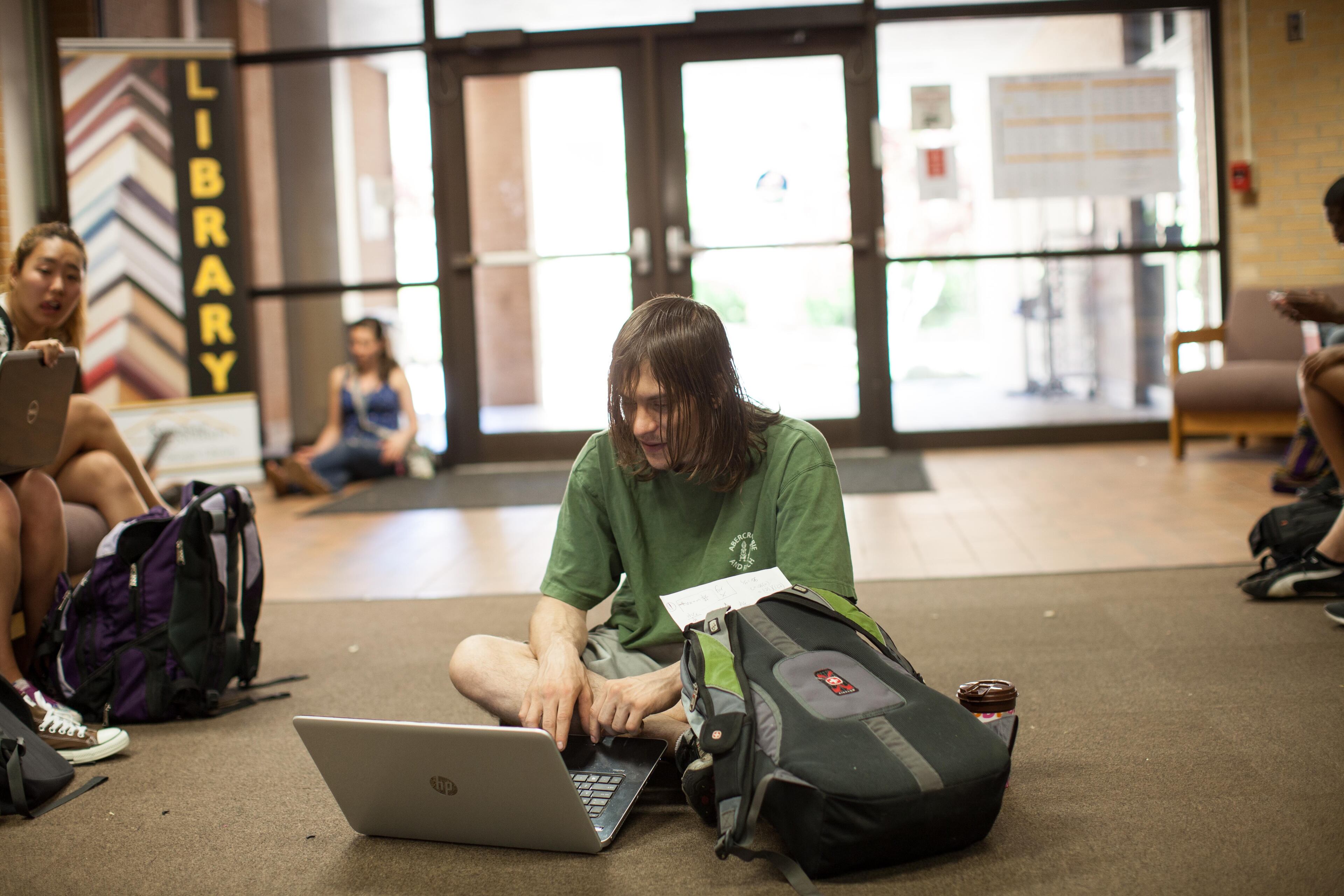 A student sits in the Library during a lockdown on Kennesaw State University's campus after students reported seeing a person with a gun Friday, April 25, 2014. (BRANDEN CAMP/SPECIAL)