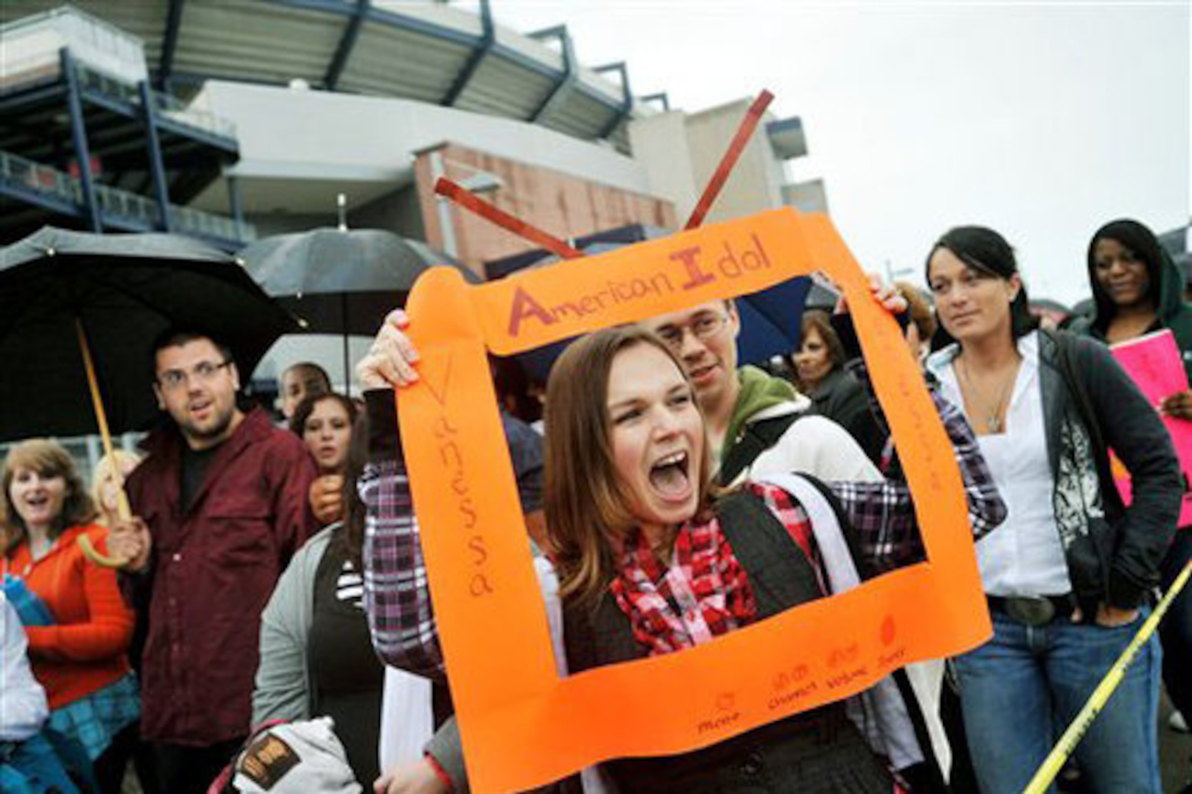 American Idol hopeful Vanessa Currier, 22, of Newton, N.H., frames her face with a mock television cut-out as she waits in line for auditions to begin.