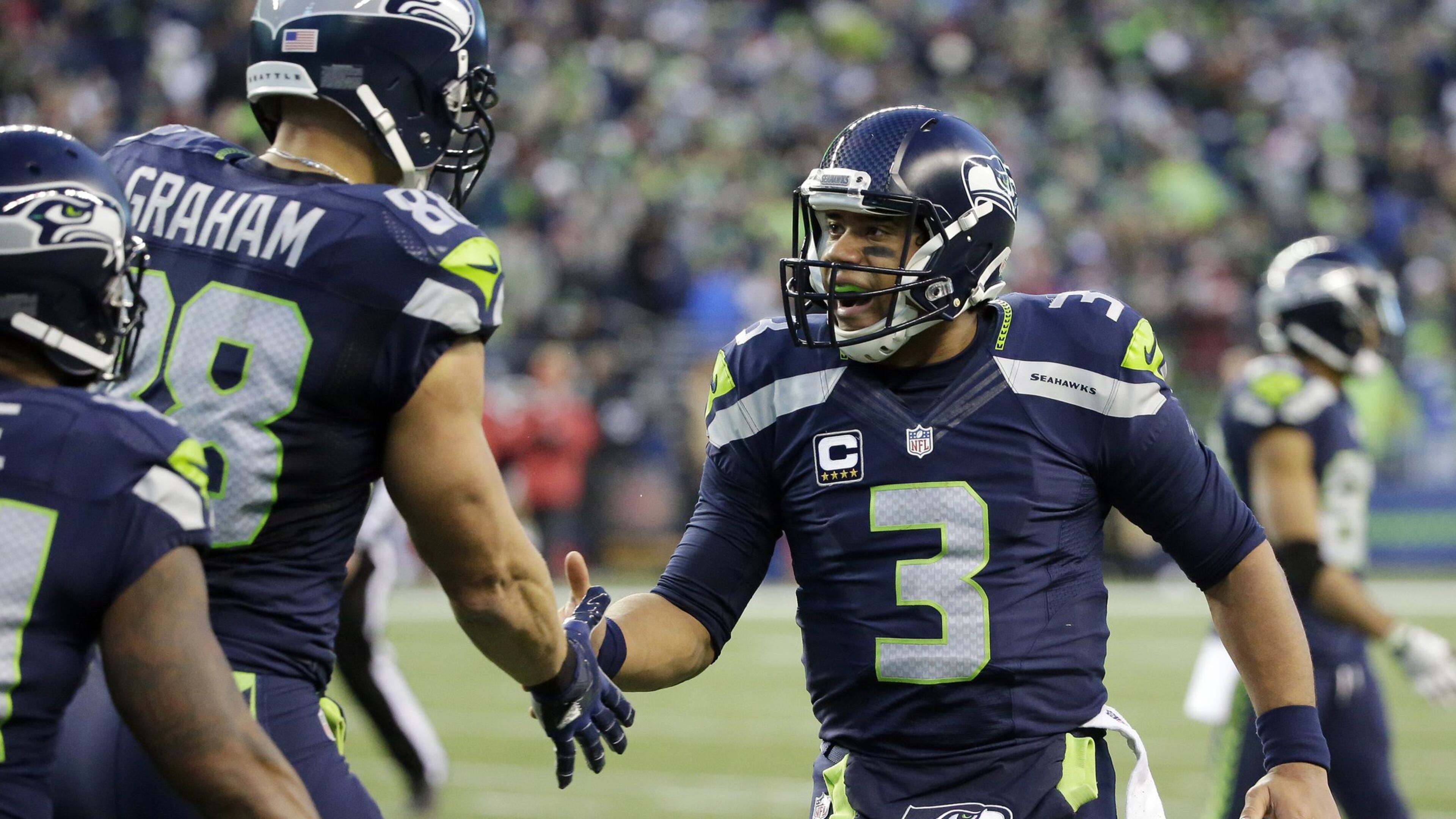 Seattle Seahawks quarterback Russell Wilson (3) greets Jimmy Graham after connecting with Graham for a 37-yard touchdown pass against the Arizona Cardinals in the second half of an NFL football game, Saturday, Dec. 24, 2016, in Seattle. (AP Photo/Ted S. Warren)