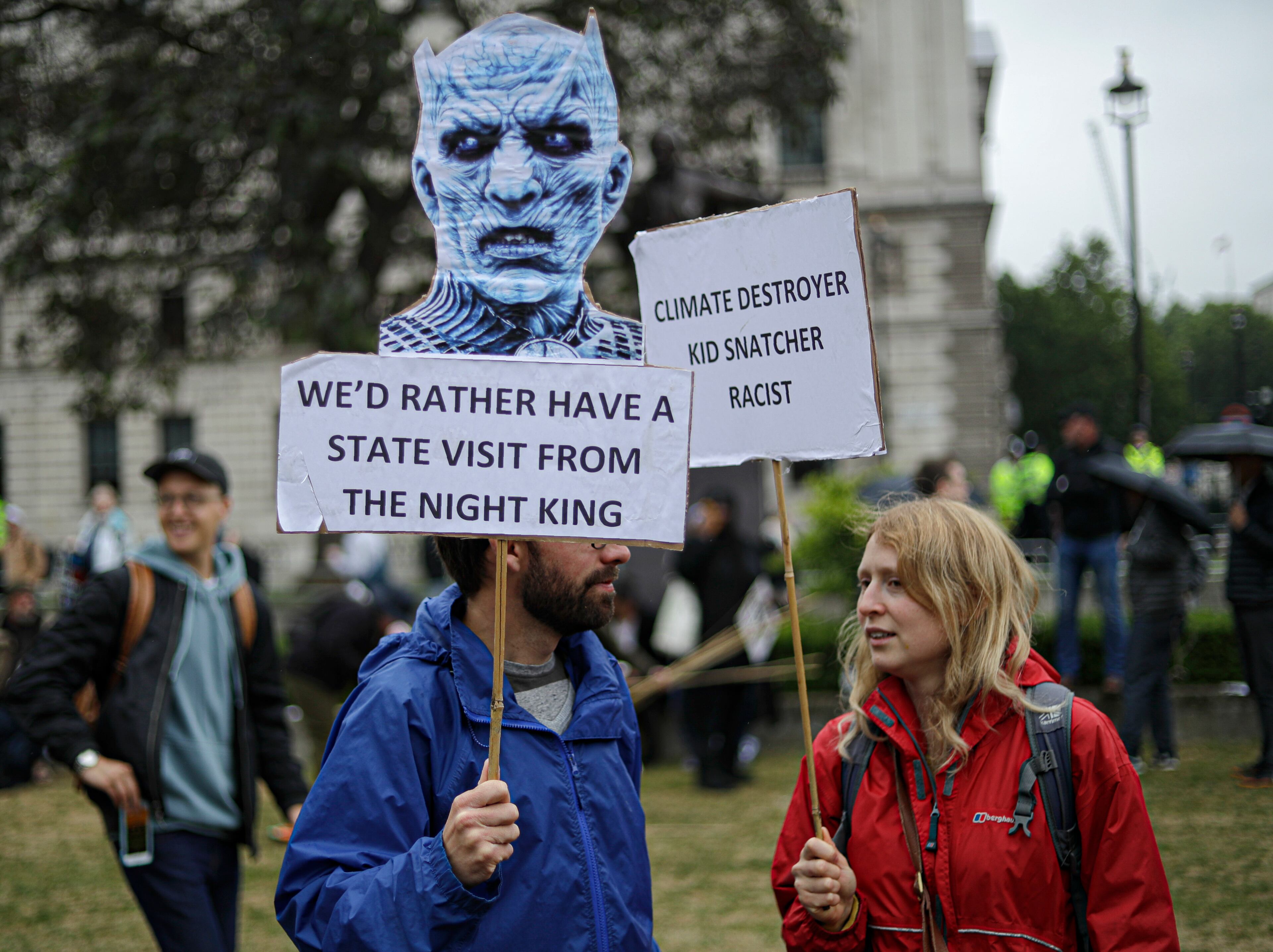 People hold placards with anti-Trump messages in central London, during a protest against the state visit of President Donald Trump, Tuesday, June 4, 2019. Trump will turn from pageantry to policy Tuesday as he joins British Prime Minister Theresa May for a day of talks likely to highlight fresh uncertainty in the allies' storied relationship. (AP Photo/Matt Dunham)