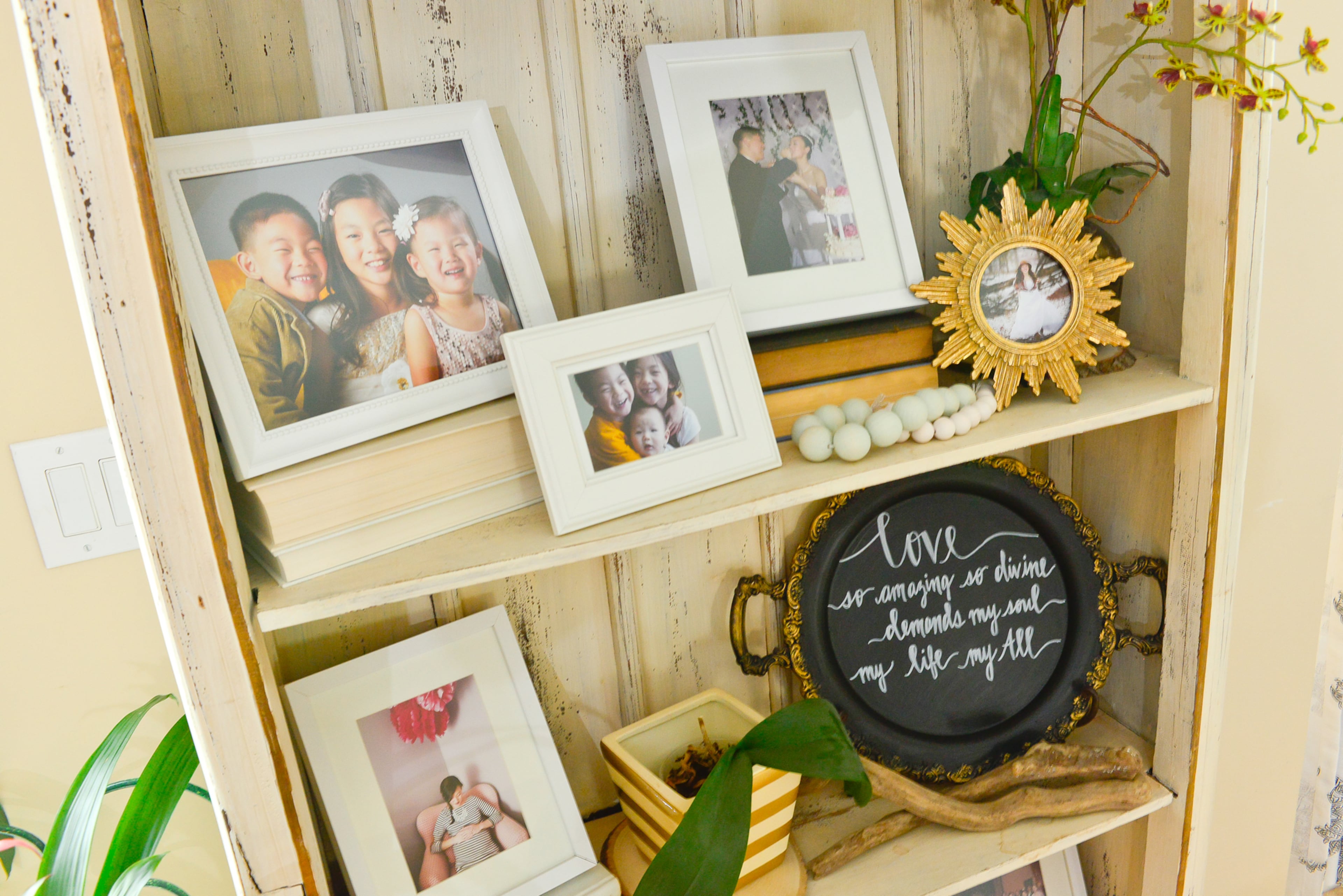 Decor: This bookcase, which has the distressed paint technique, is one of homeowner Yuni Min's favorite pieces of furniture. The shelf displays family photos of Yuni, her husband Jimmy, and their three children.