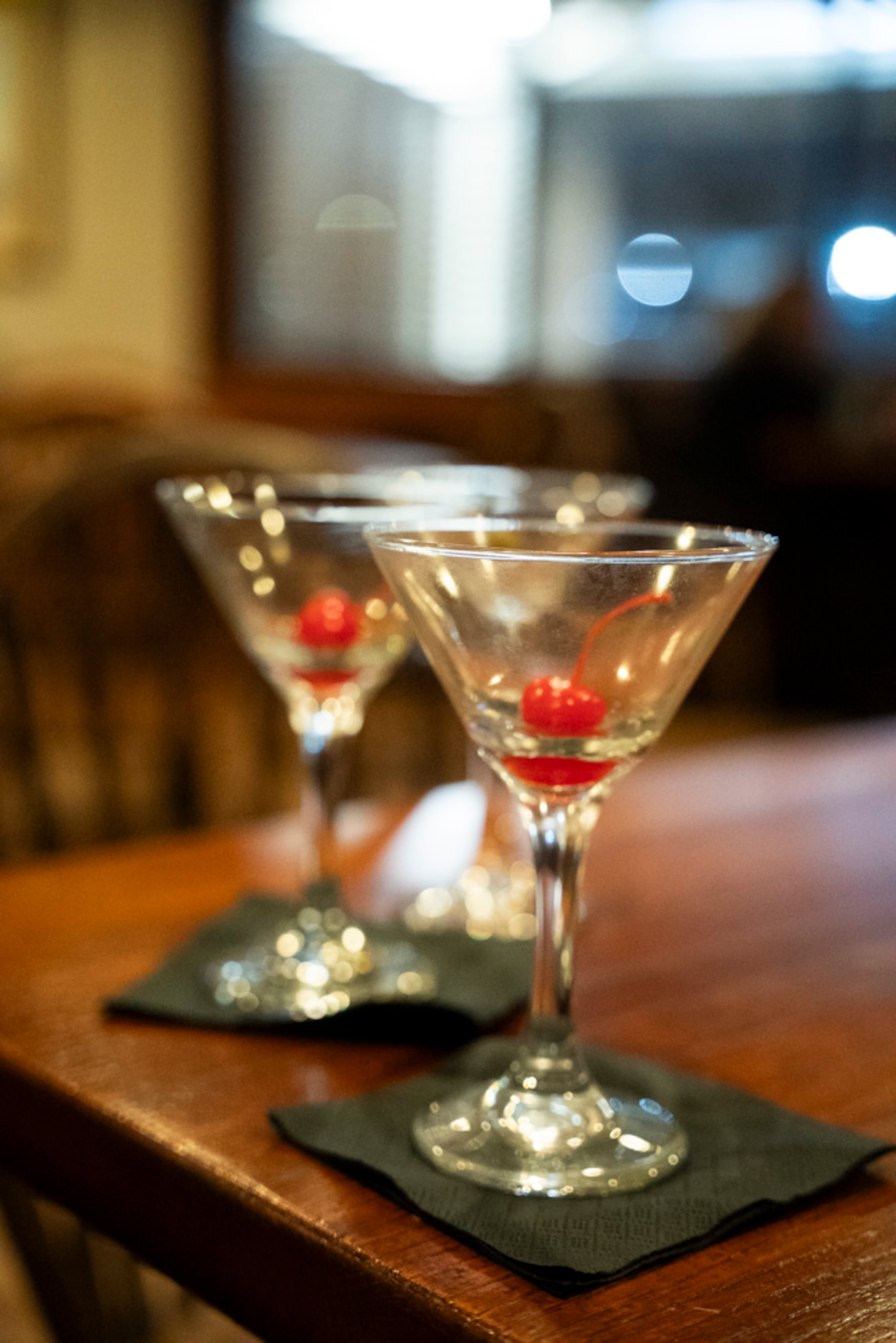 Two empty martini glasses sit on a table at The Colonnade, a restaurant that has been operating since 1927 in Atlanta. (Olivia Bowdoin for the AJC 2024)