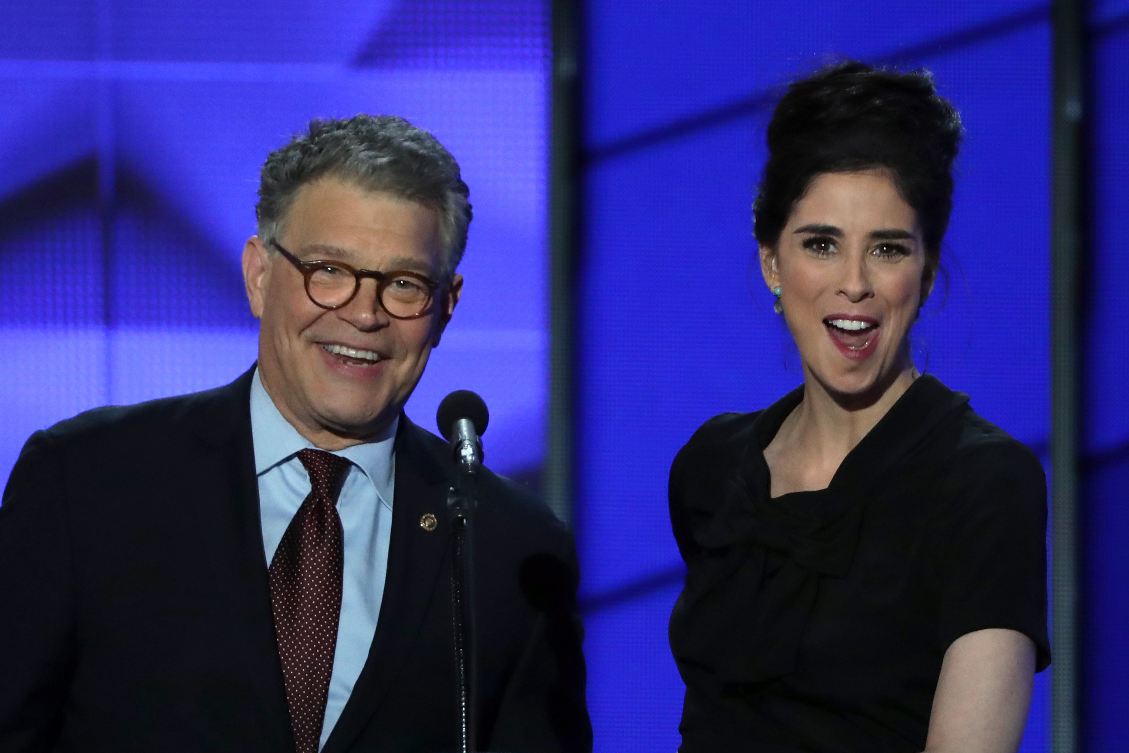 Sen. Al Franken (D-MN) speaks as comedian/actress Sarah Silverman speaks looks on during the first day of the Democratic National Convention at the Wells Fargo Center, July 25, 2016 in Philadelphia, Pennsylvania. An estimated 50,000 people are expected in Philadelphia, including hundreds of protesters and members of the media. The four-day Democratic National Convention kicked off July 25. (Photo by Alex Wong/Getty Images)
