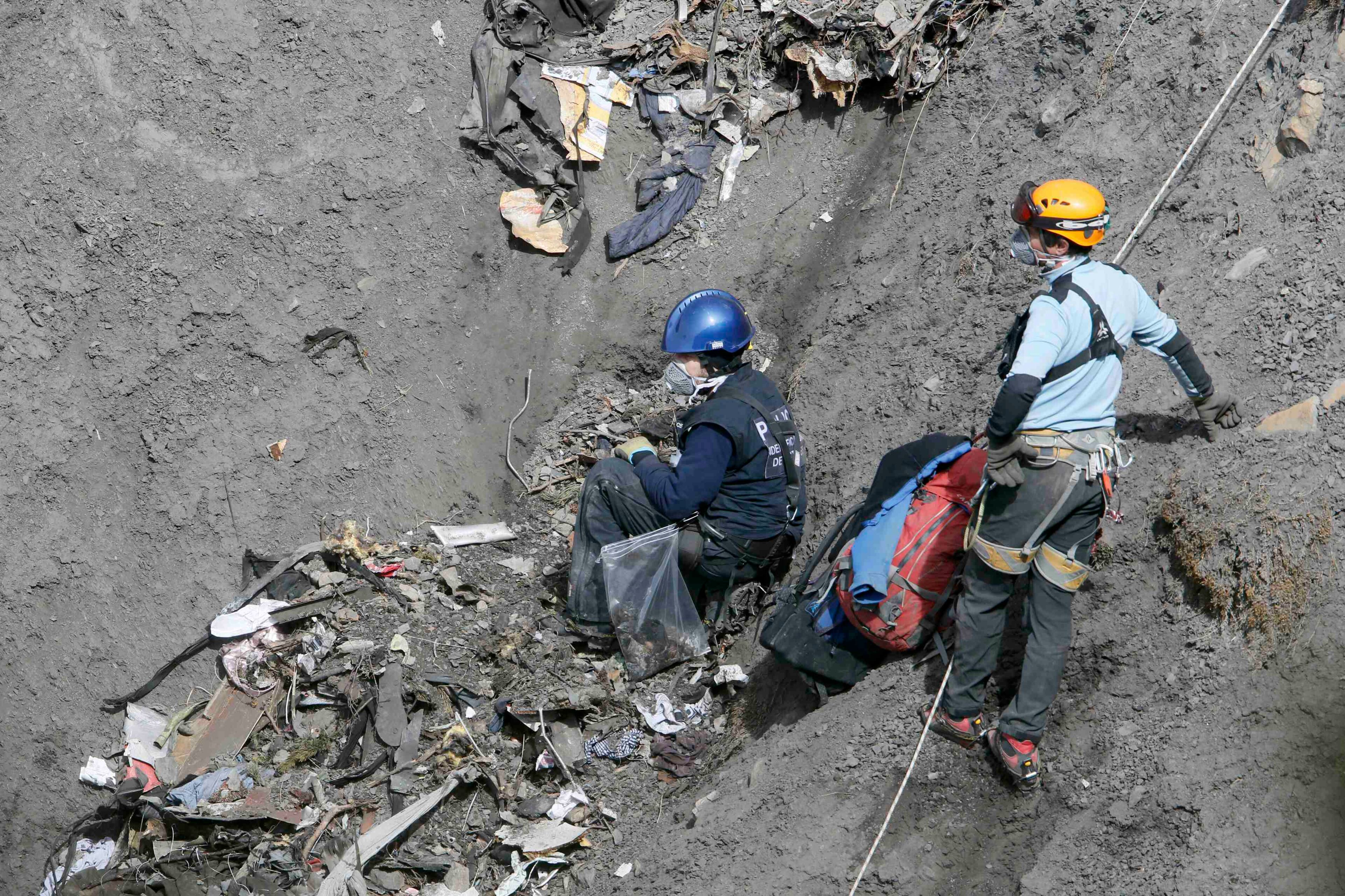 French investigators inspect the remains of the Airbus A320 at the site of the crash, near Seyne-les-Alpes, French Alps March 29, 2015. The co-pilot suspected of deliberately crashing a passenger plane in the French Alps told his girlfriend he was in psychiatric treatment, and that he was planning a spectacular gesture that everyone would remember, the German daily Bild reported on Saturday. REUTERS/Gonzalo Fuentes