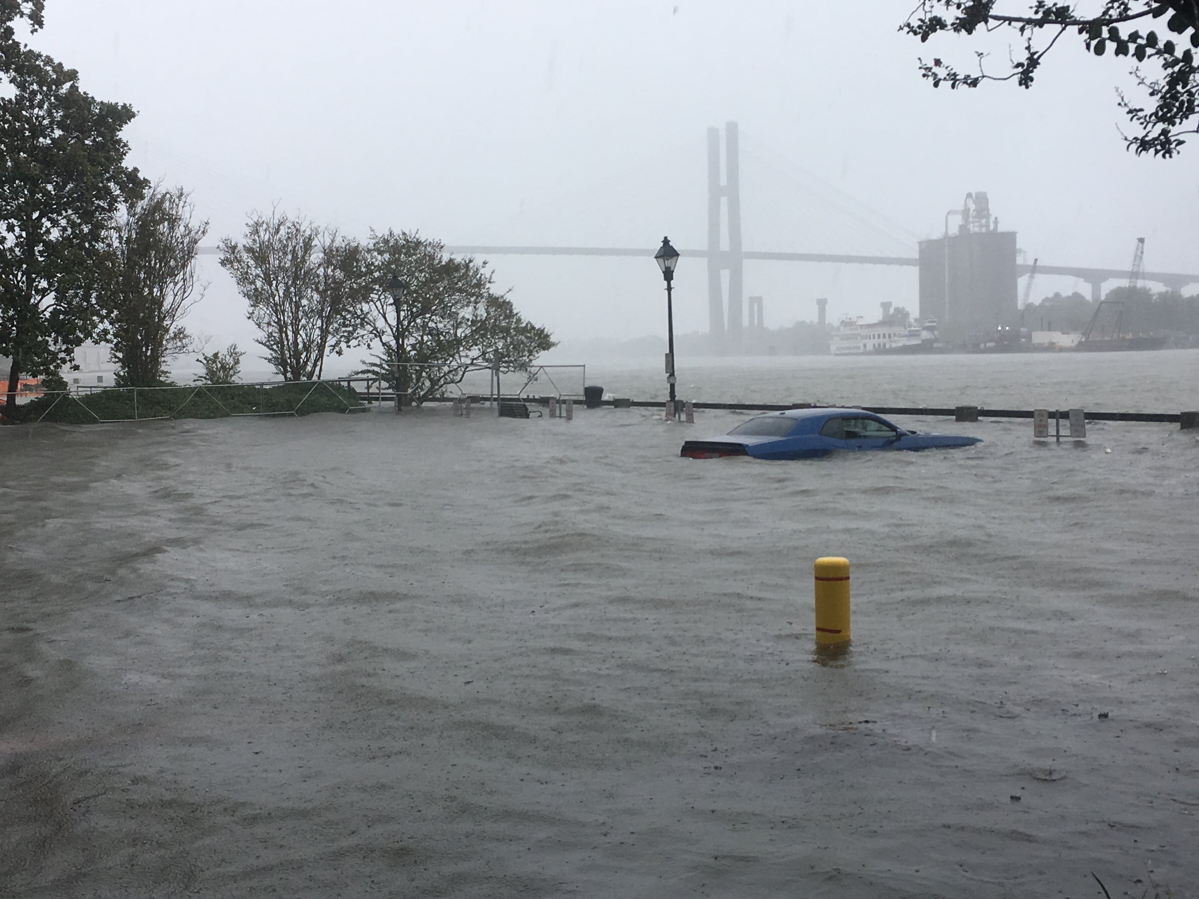 A car on River Street in downtown Savannah is inundated by water from the Savannah River on Monday, September 11, 2017, following heavy rain and storm surge from Tropical Storm Irma. JENNIFER BRETT/JBRETT@AJC.COM