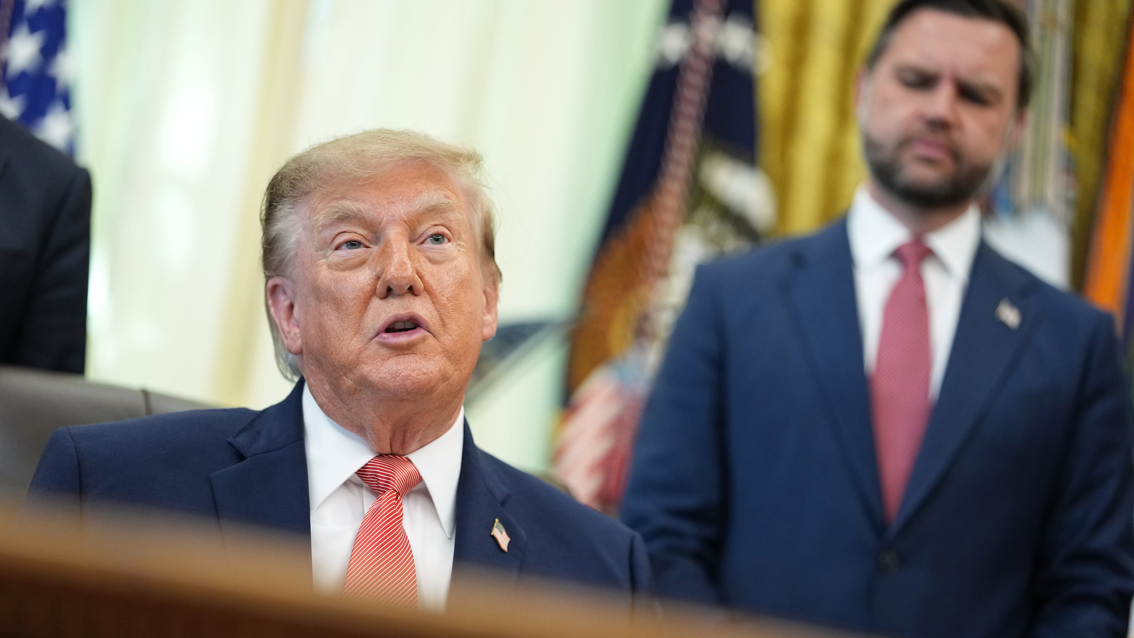 President Donald Trump speaks in the Oval Office of the White House, Tuesday, Oct. 20, 2026, in Washington, as Vice President JD Vance listens. (AP Photo/Jacquelyn Martin)