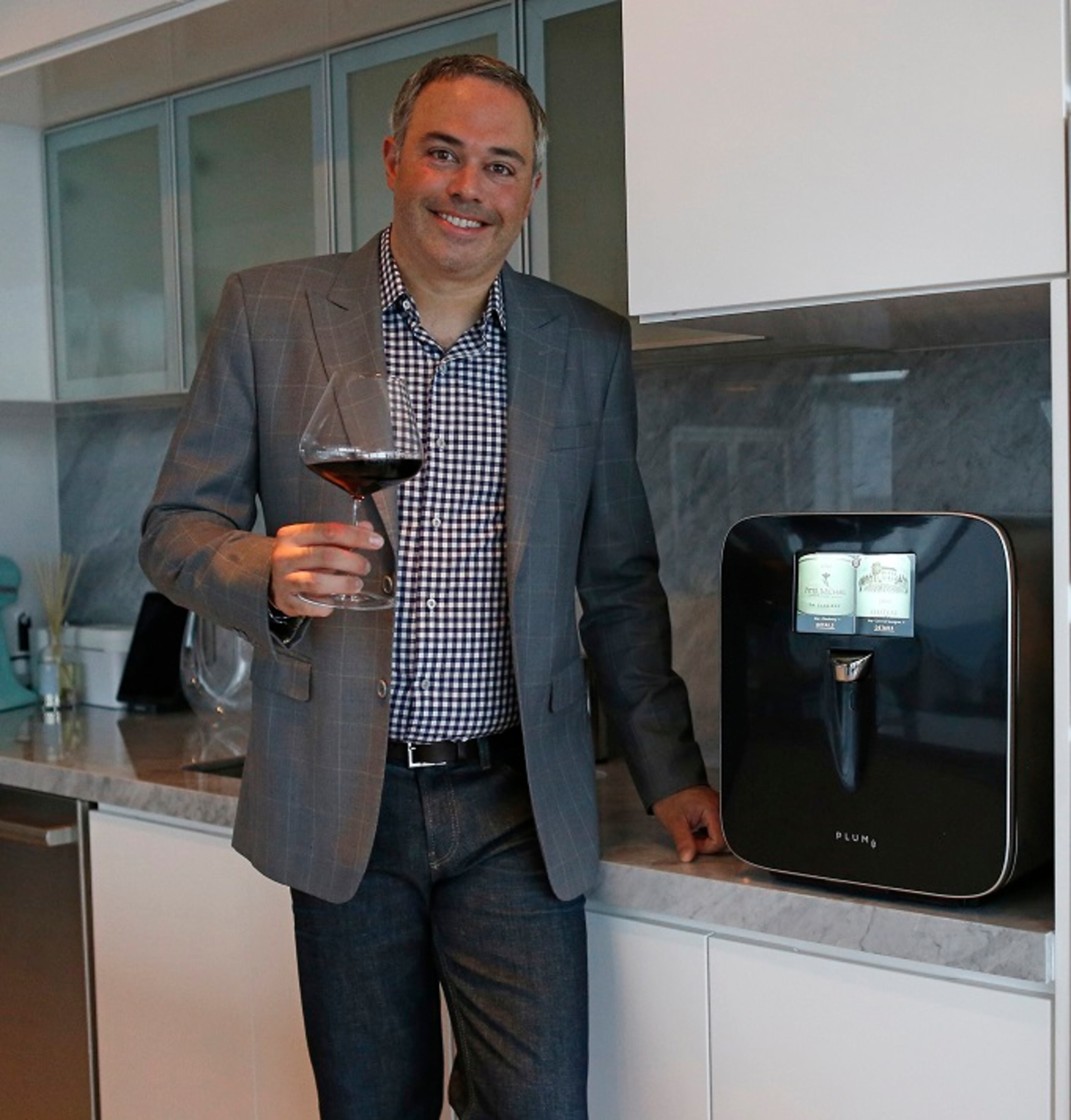 David Koretz, CEO of Plum, poses for the pictures at his home on Wednesday, Sept. 6, 2017 in Miami, Fla. David Koretz' company Plum has created a high-tech wine appliance that serves wine at the perfect temperature and can save it for months, still serving wine as it was intended. (David Santiago/Miami Herald/TNS)