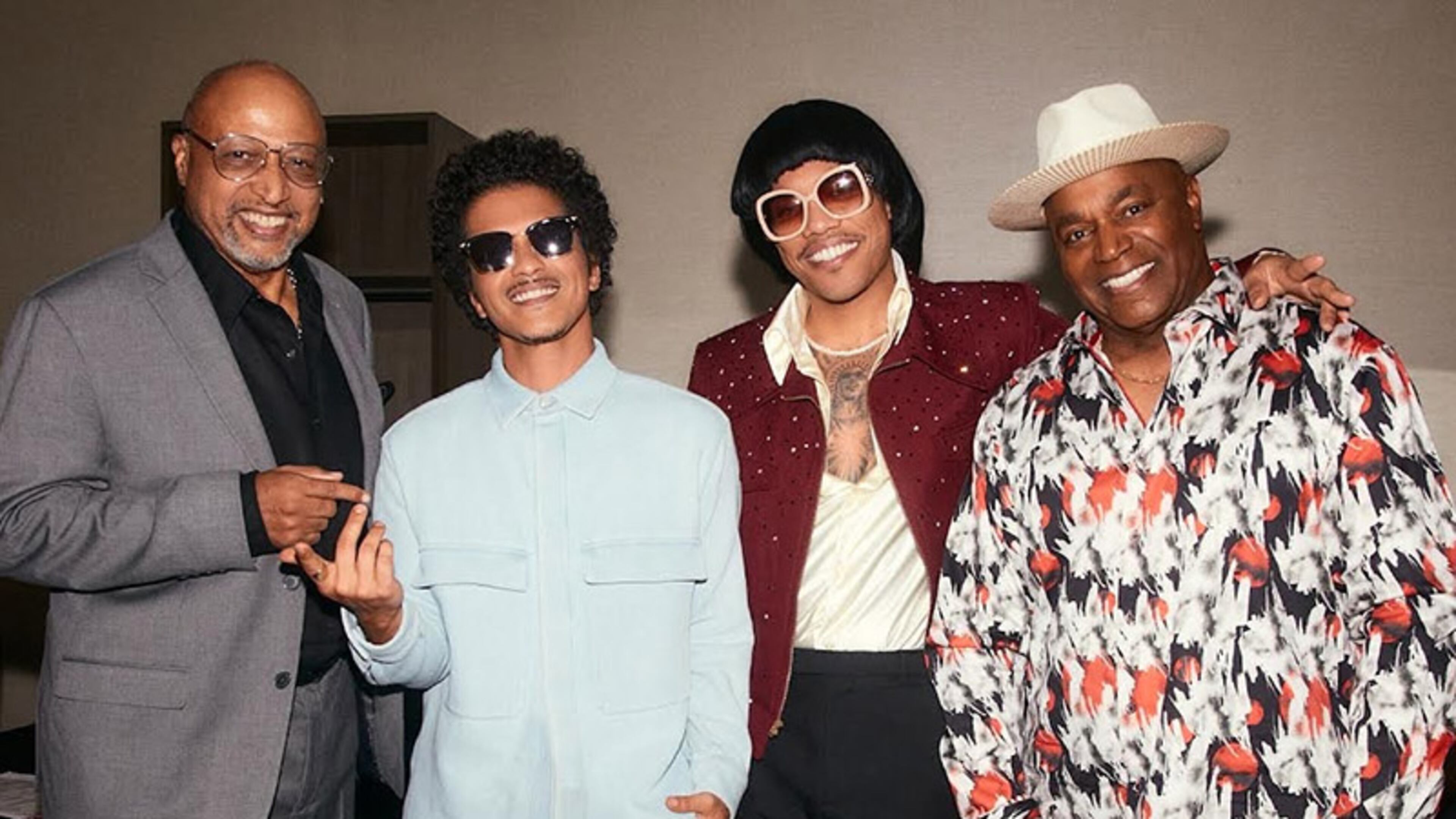 Silk Sonic members Bruno Mars and Anderson .Paak meet Con Funk Shun members Michael Cooper and Felton Pilate. Silk Sonic recently covered Con Funk Shun's "Love's Train."